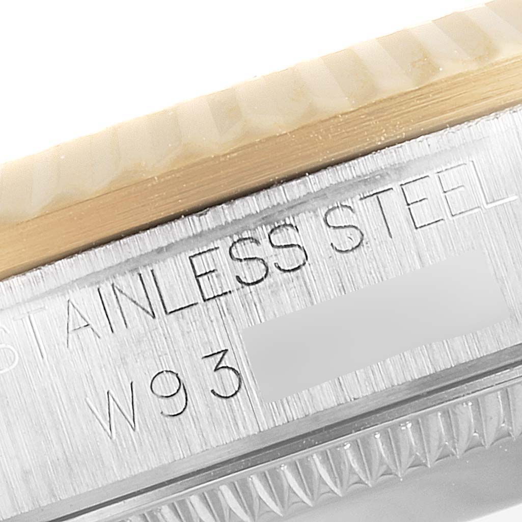 This image shows a close-up of the side of a Rolex Mid-Size 68273 Women
s Steel and Gold (two tone) White Dial 68273 Women
s Steel and Gold (two tone) White Dial watch, revealing part of the case with "STAINLESS STEEL" engraving.