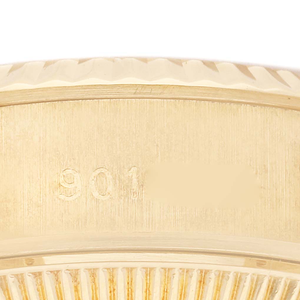 This close-up image of a Rolex President 69178 Women's Yellow Gold White Dial 69178 Women's Yellow Gold White Dial model shows the serial number engraving on the case side.