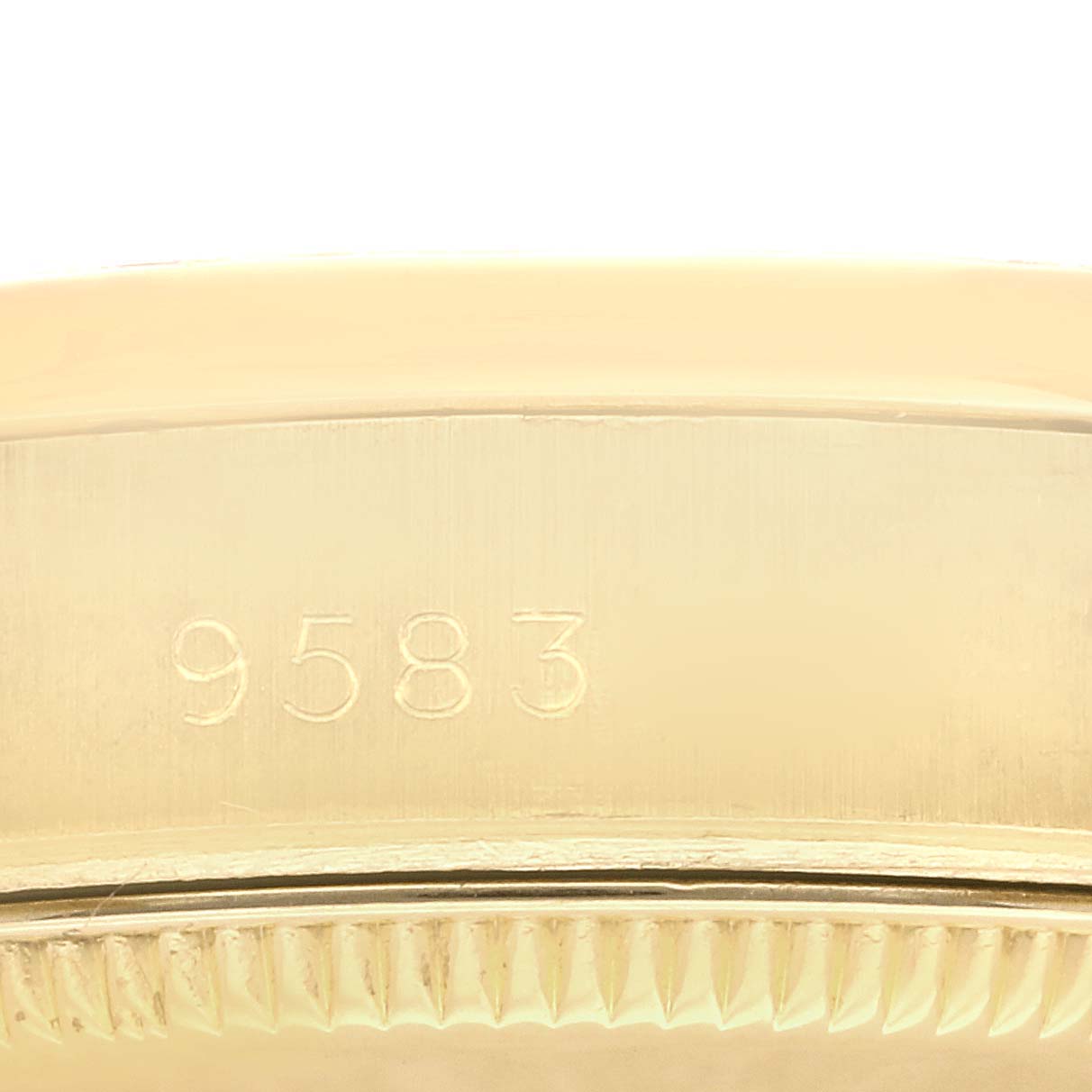 This close-up image shows the serial number and the edge of the case back of a Rolex President 68158 Women's Yellow Gold Champagne Dial 68158 Women's Yellow Gold Champagne Dial model watch.