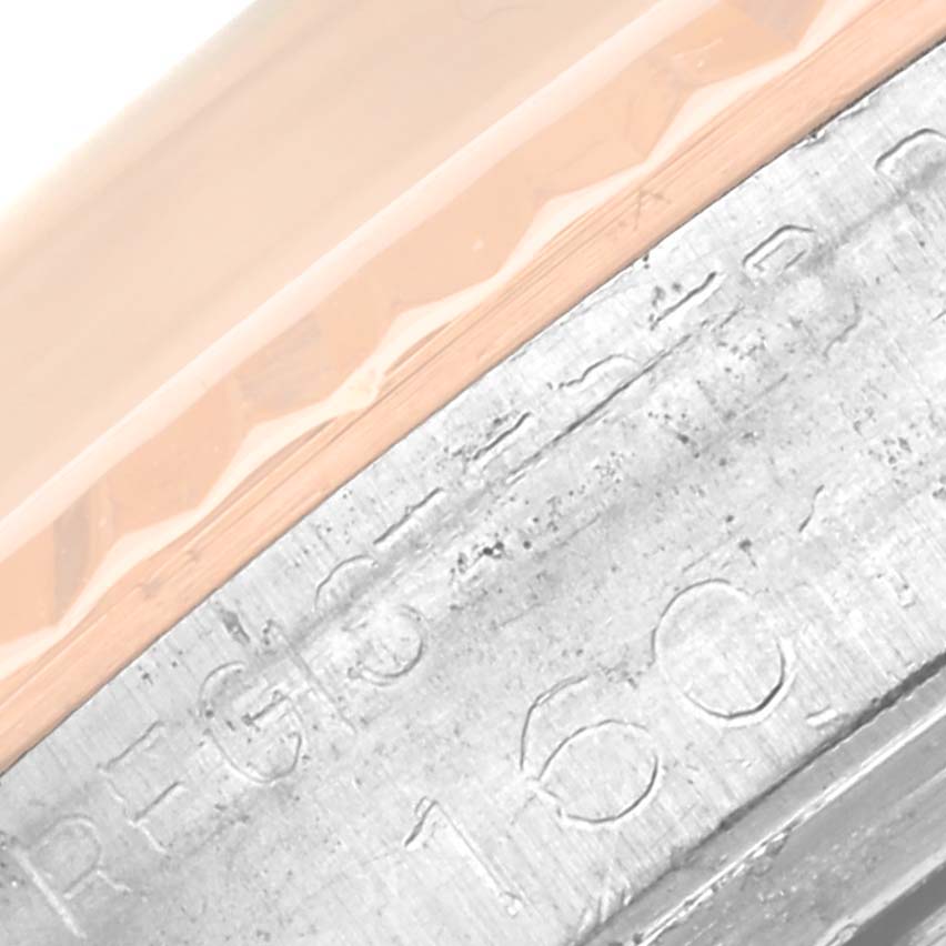 This close-up image of a Rolex Vintage Collection 1601 Men's Steel and Gold (two tone) Silver Dial 1601 Men's Steel and Gold (two tone) Silver Dial model shows part of the bezel and engraved serial number on the case.