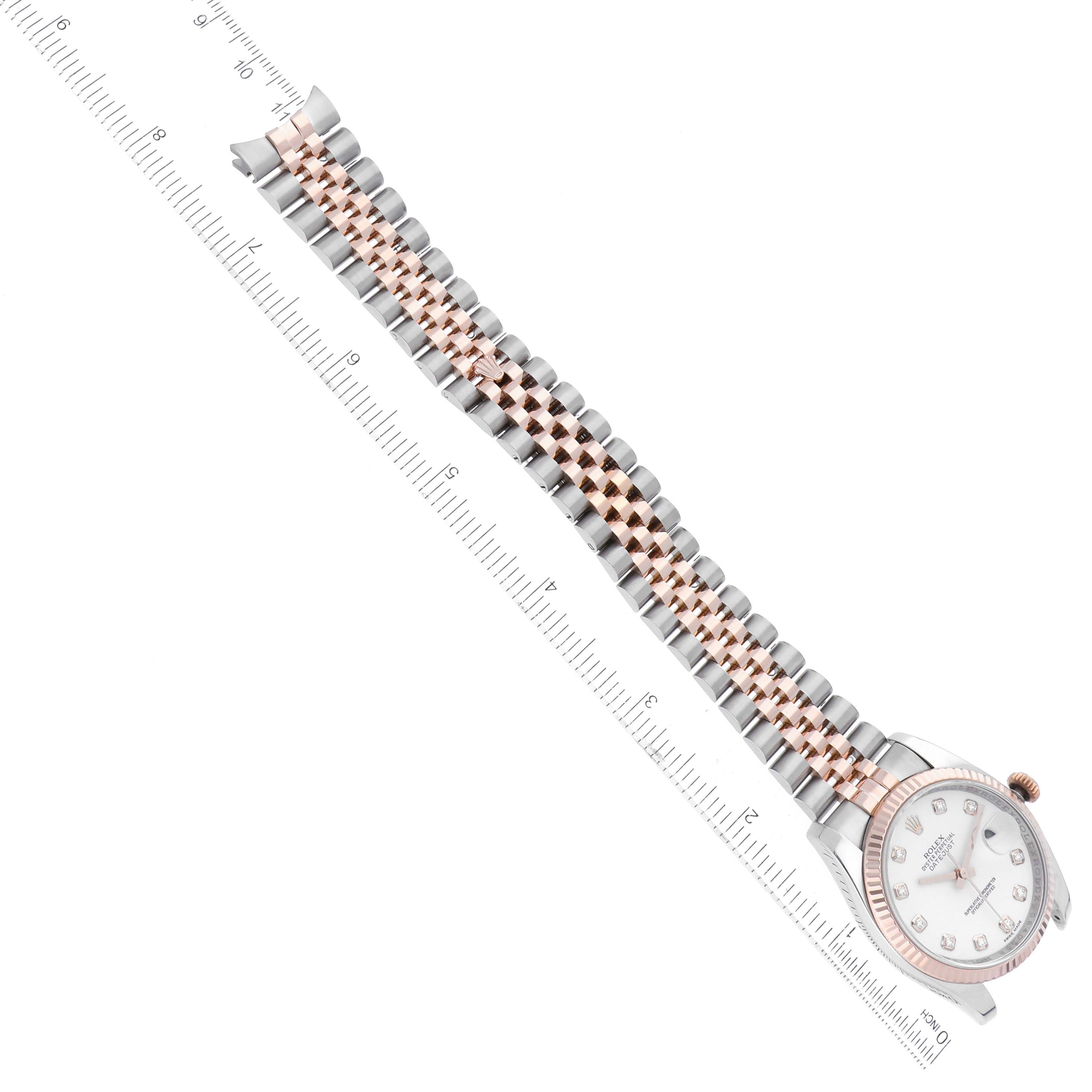 The image shows a Rolex Datejust 116231 Men's Steel and Gold (two tone) White Dial 116231 Men's Steel and Gold (two tone) White Dial watch laid at an angle with its metal band aligned with a ruler.