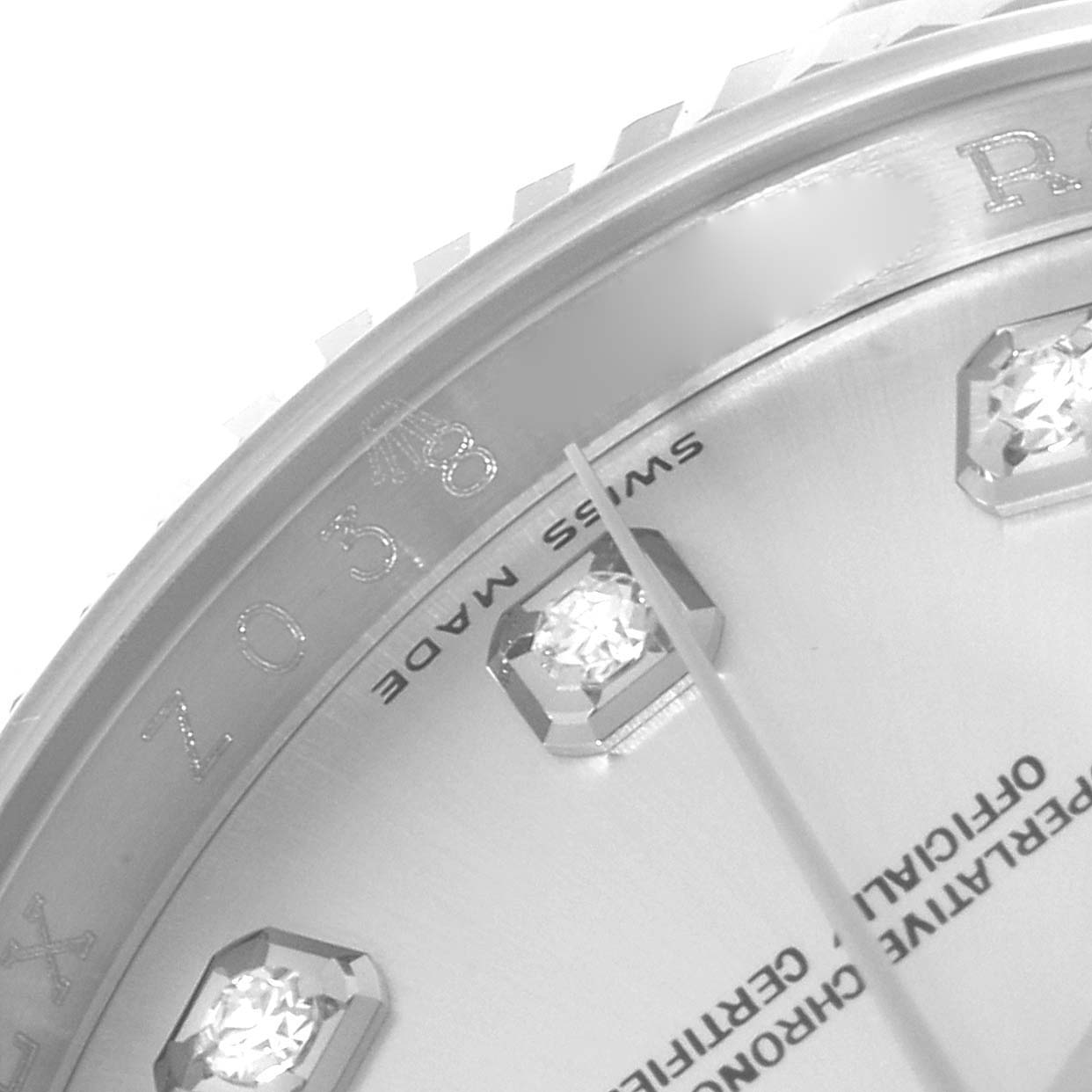 This close-up of a Rolex Datejust 116234 Men's Stainless Steel Silver Dial 116234 Men's Stainless Steel Silver Dial watch shows part of the dial, indices, and the chapter ring.