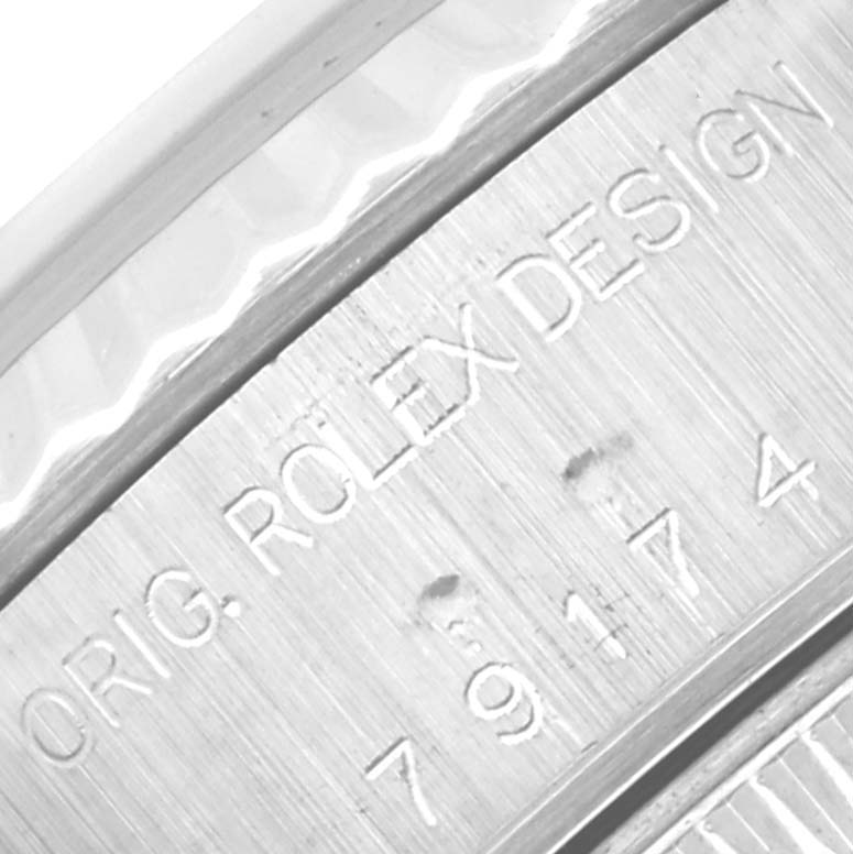 The image shows a close-up of the engraved inner bezel on a Rolex Datejust 79174 Women's Stainless Steel White Dial 79174 Women's Stainless Steel White Dial watch, displaying the text "ORIG. ROLEX DESIGN."