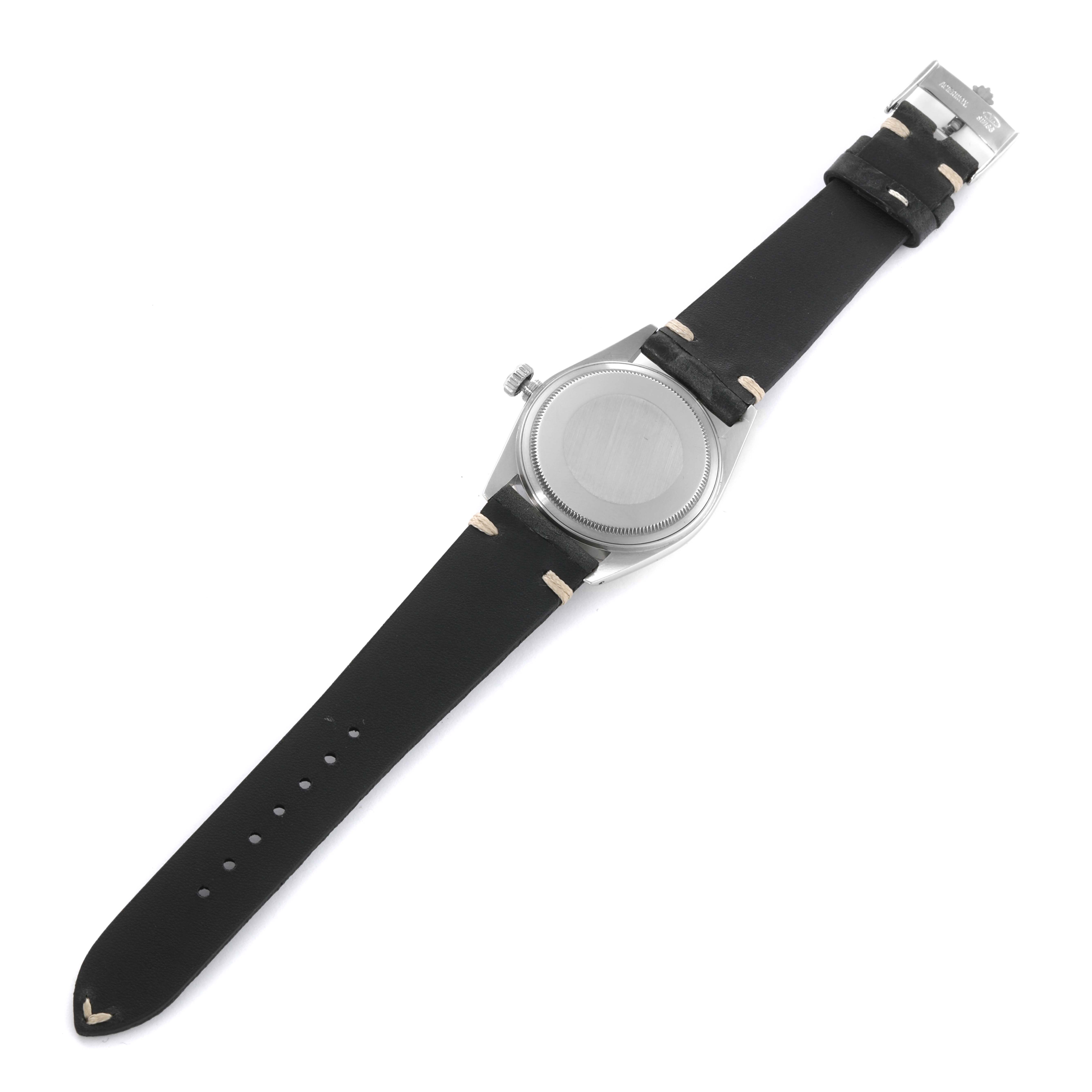 This image shows the back and black strap of a Rolex Vintage Collection 16014 Men's Stainless Steel Silver Dial 16014 Men's Stainless Steel Silver Dial watch, showcasing its case and crown.