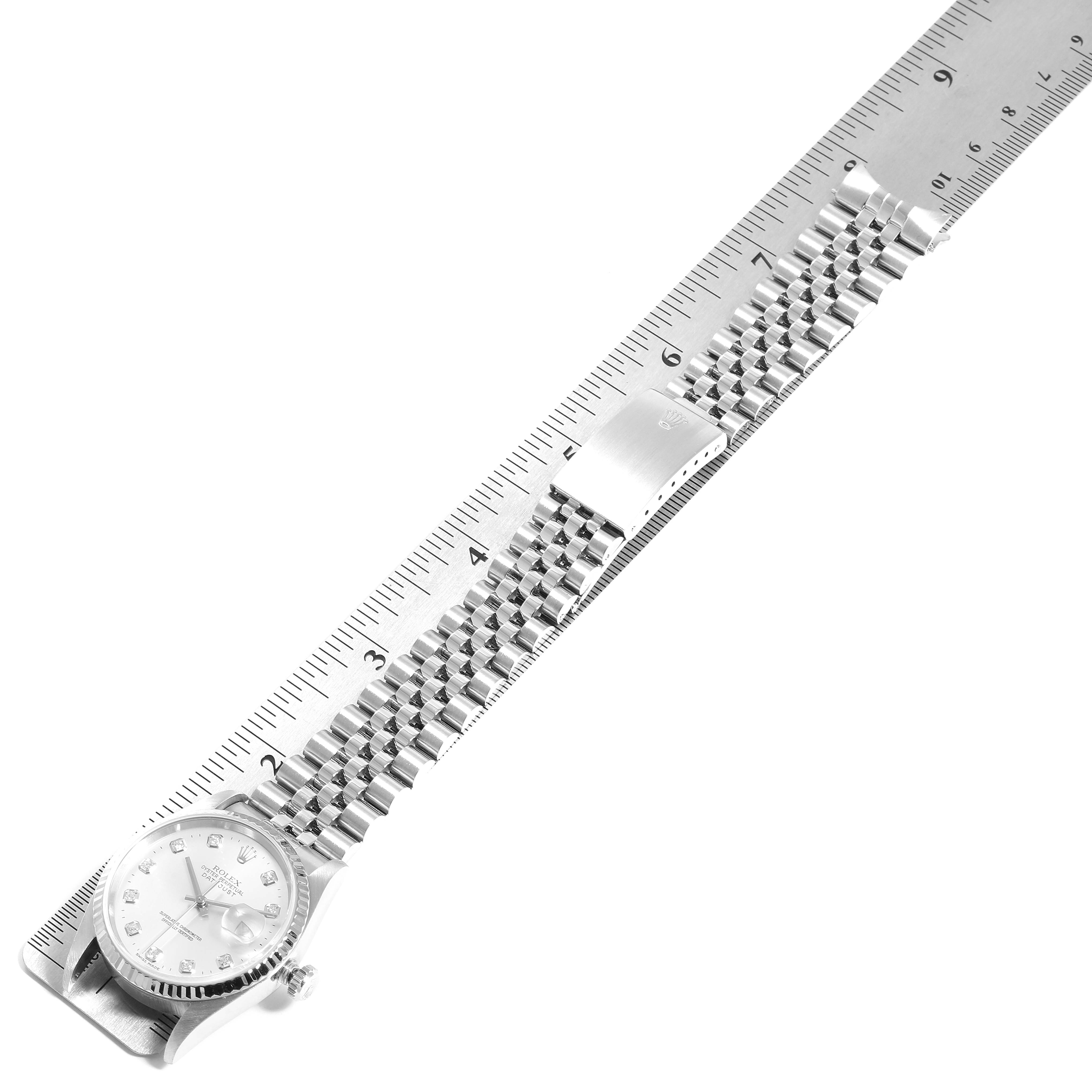 The image shows a Rolex Datejust 16234 Men's Stainless Steel Silver Dial 16234 Men's Stainless Steel Silver Dial watch laid flat next to a ruler, showcasing the dial and metal bracelet.