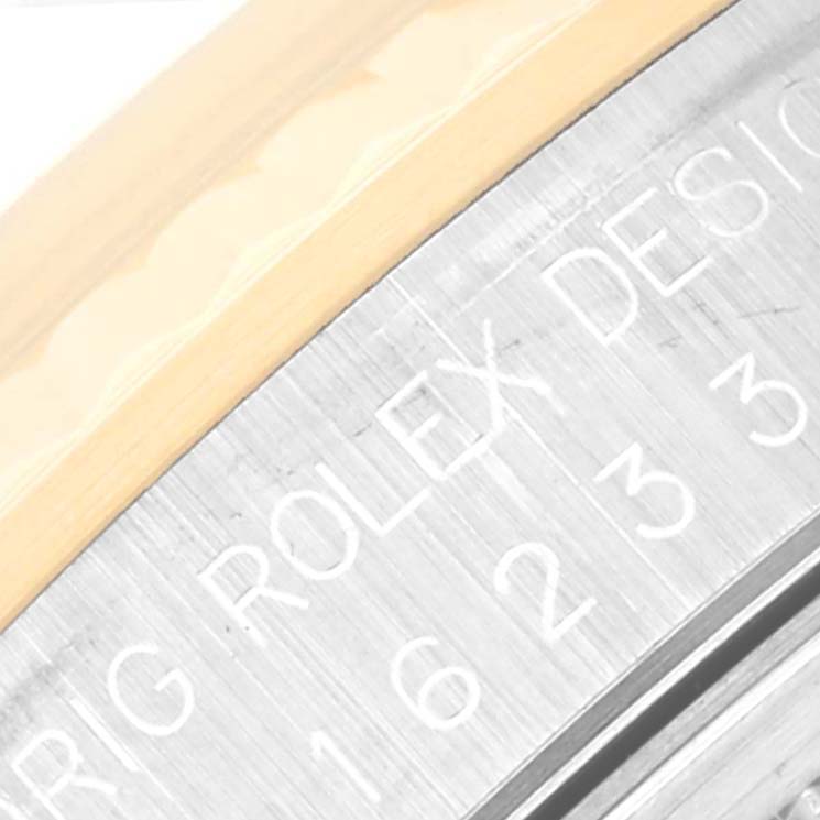 This close-up image shows part of the bezel and engraved case of the Rolex Datejust 16233 Men's Steel and Gold (two tone) Black Dial 16233 Men's Steel and Gold (two tone) Black Dial watch.
