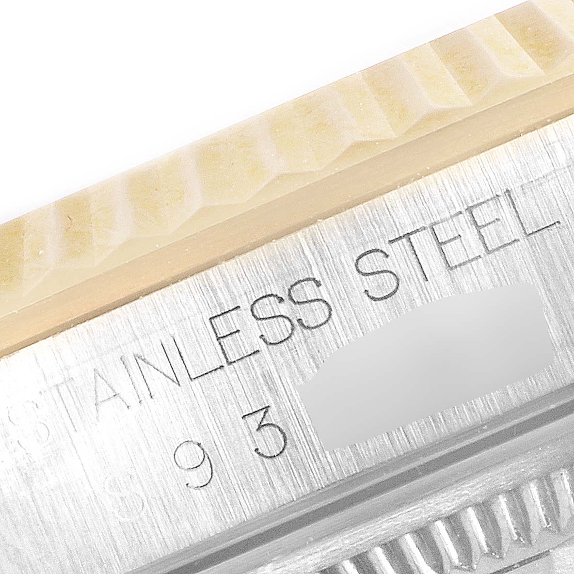 The image shows a close-up of the bezel and possibly the case back of a Rolex Datejust 16233 Men's Steel and Gold (two tone) Champagne Dial 16233 Men's Steel and Gold (two tone) Champagne Dial model, displaying "STAINLESS STEEL" text.