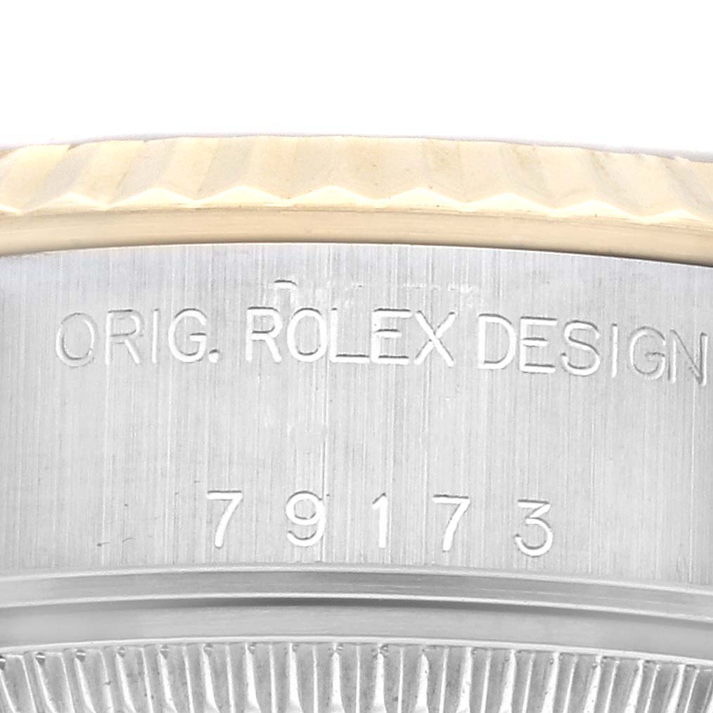 The image shows a close-up of the side engraving on a Rolex Datejust 79173G Women's Steel and Gold (two tone) Champagne Dial 79173G Women's Steel and Gold (two tone) Champagne Dial watch case, featuring "ORIG. ROLEX DESIGN" and model number 79173.