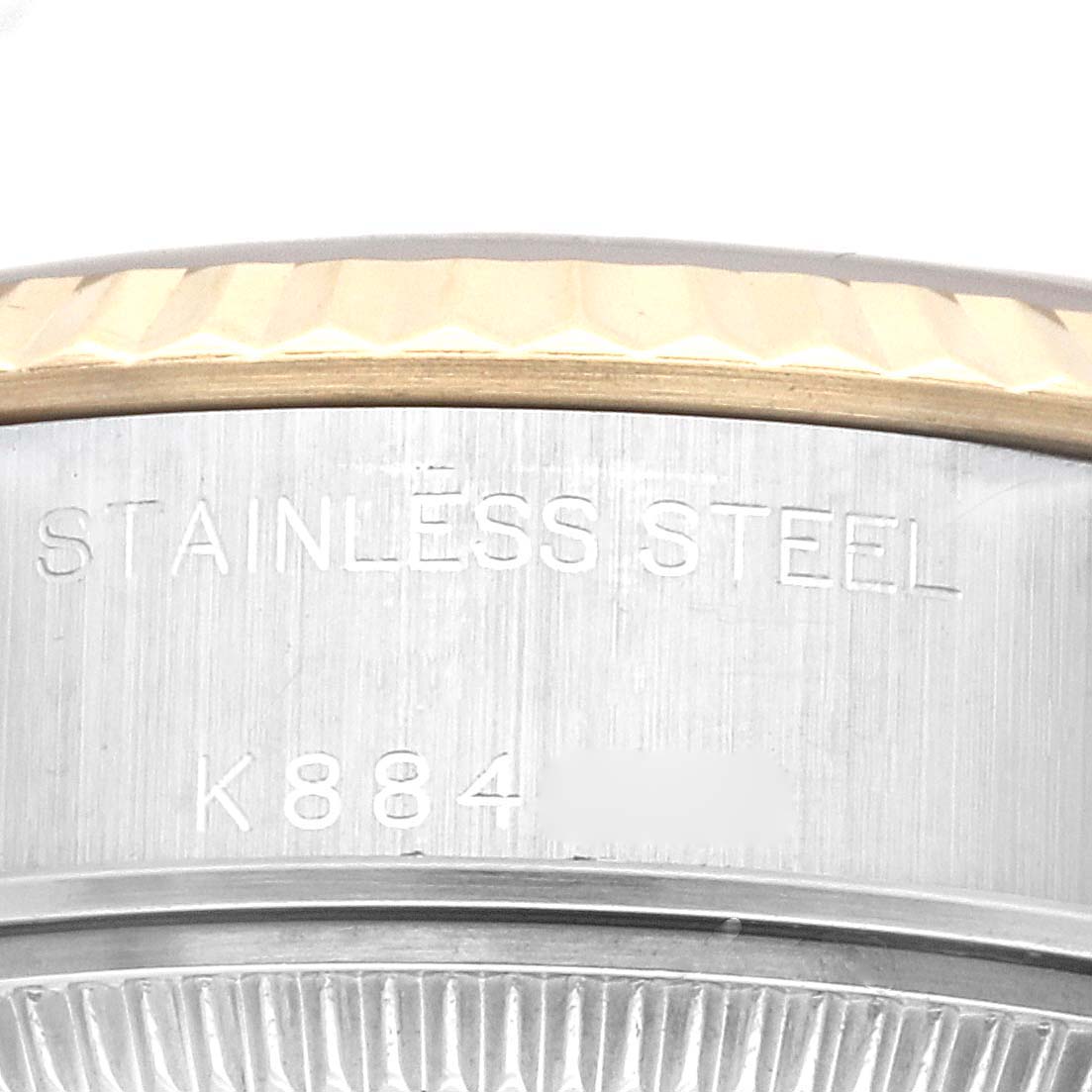 The image shows a close-up of the side case of a Rolex Datejust 79173G Women's Steel and Gold (two tone) Champagne Dial 79173G Women's Steel and Gold (two tone) Champagne Dial watch, focusing on the stainless steel marking and partial serial number.