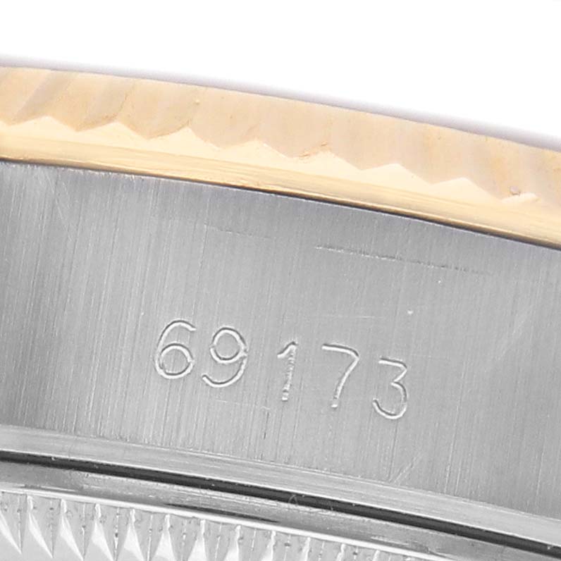 The image shows a close-up of the model number "69173" etched on the case band of a Rolex Datejust 69173 Women's Steel and Gold (two tone) Champagne Dial watch.