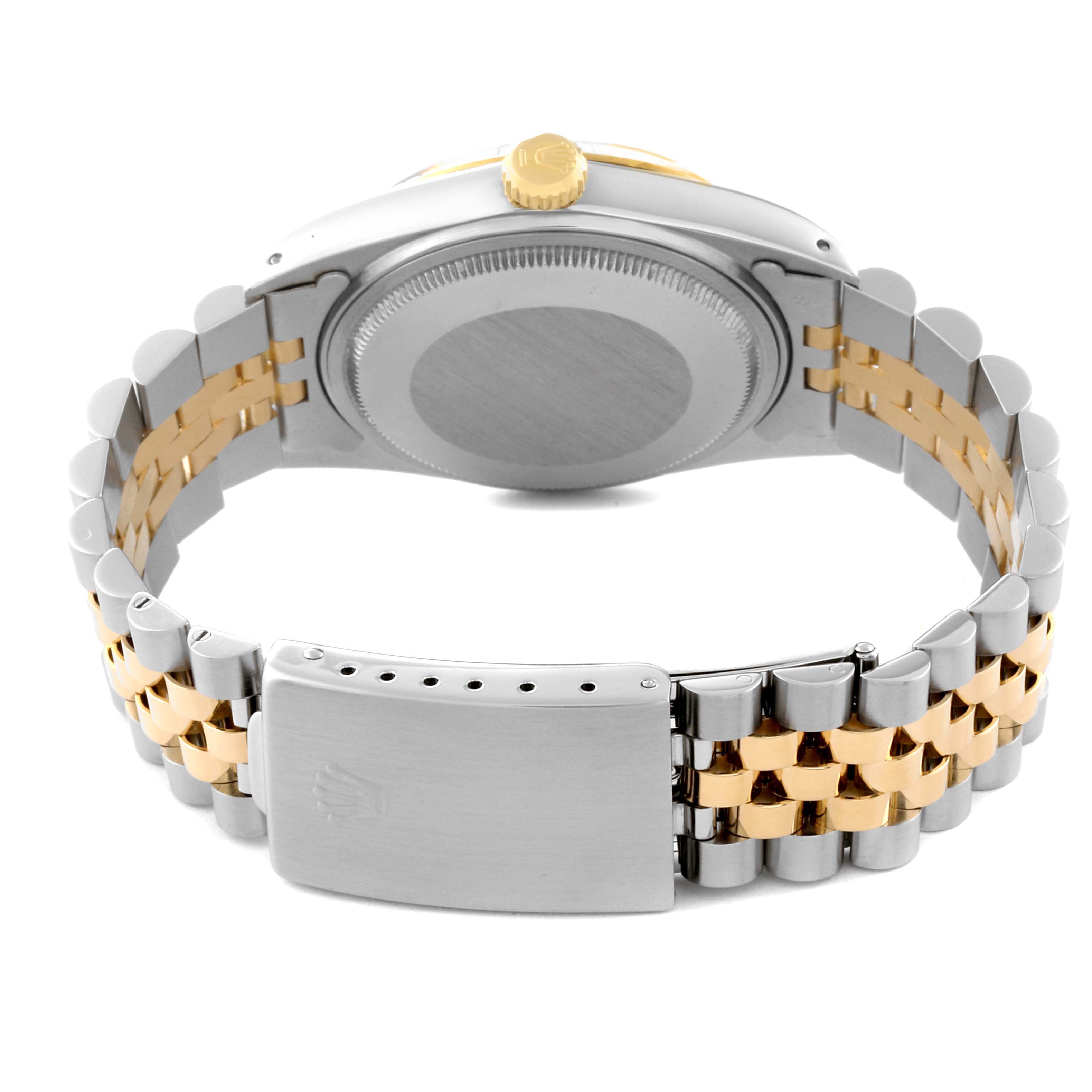 This image shows the back and clasp of a Rolex Vintage Collection 16013 Men
s Steel and Gold (two tone) Champagne Dial 16013 Men
s Steel and Gold (two tone) Champagne Dial watch, highlighting its two-tone strap and case back.