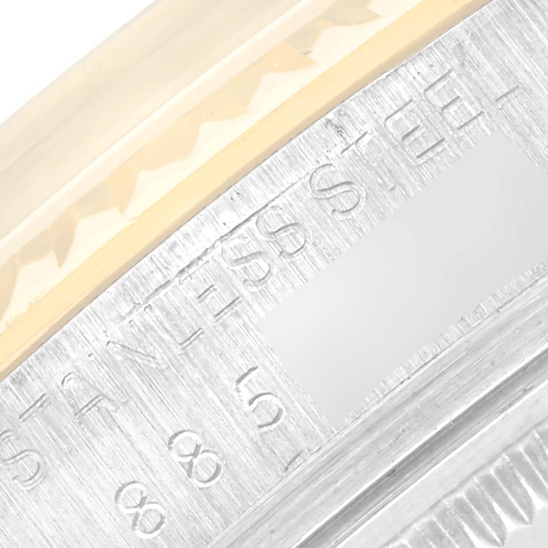 This close-up image of the Rolex Vintage Collection 16013 Men
s Steel and Gold (two tone) Champagne Dial 16013 Men
s Steel and Gold (two tone) Champagne Dial model shows part of the bezel and engraved text on the stainless steel case.