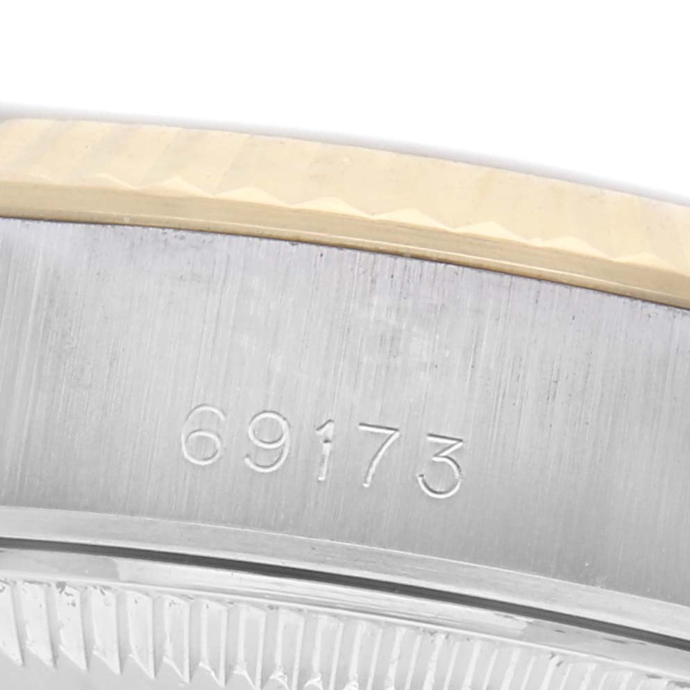 The image shows a close-up of the side of a Rolex Datejust 69173 Women's Steel and Gold (two tone) Champagne Dial 69173 Women's Steel and Gold (two tone) Champagne Dial, displaying the model number and part of the bezel.