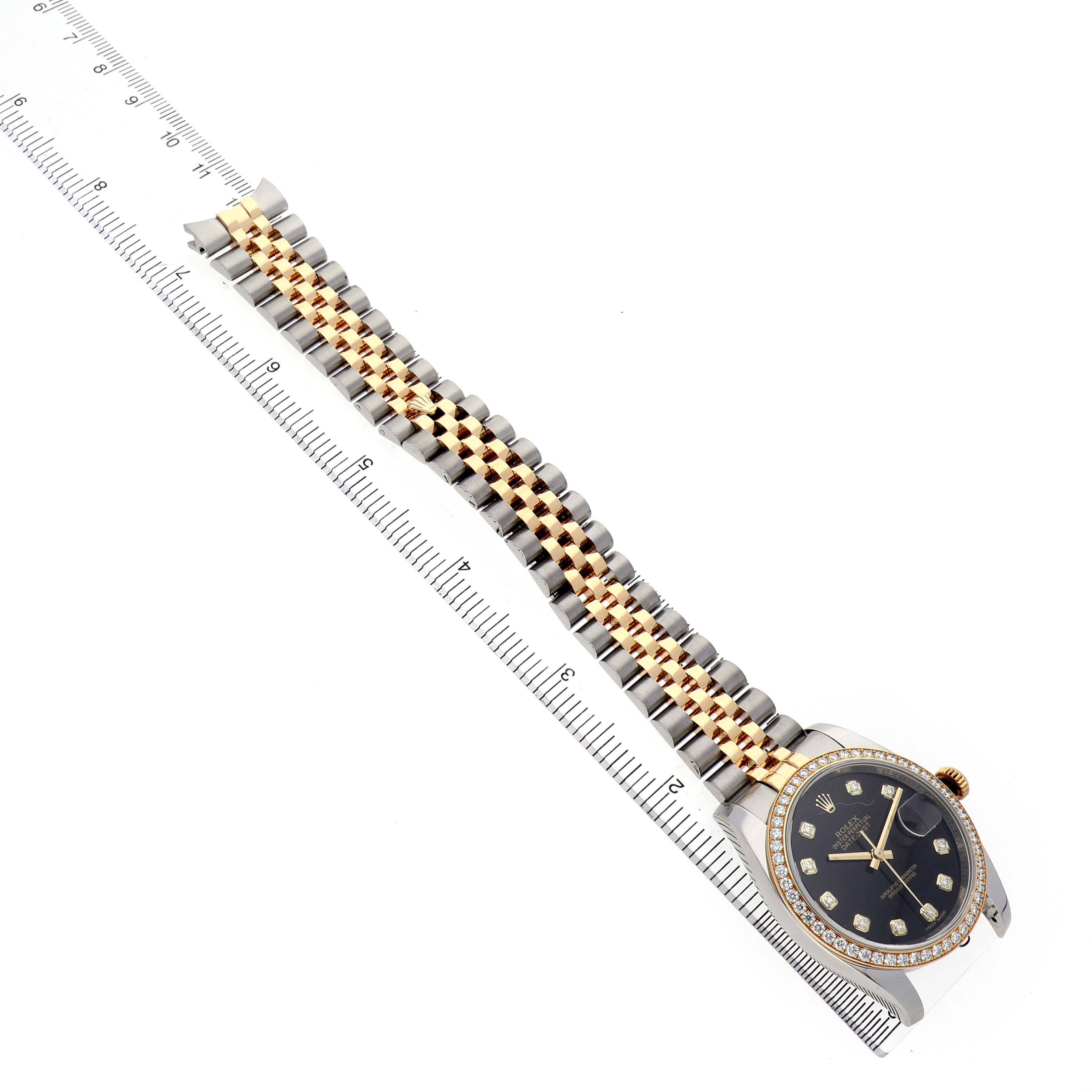 The Rolex Datejust 116243 Men's Steel and Gold (two tone) Black Dial watch is shown from a top-down angle, highlighting its two-tone bracelet, bezel, and dial.