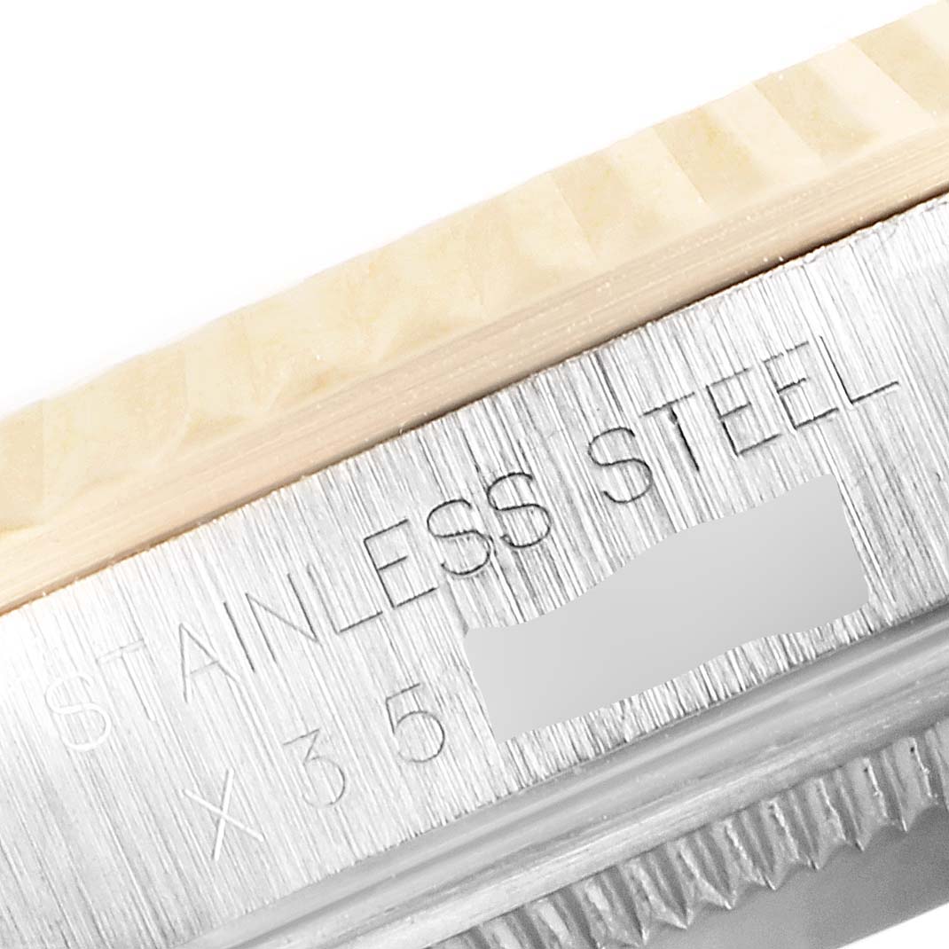 The image shows a close-up of a stainless steel part of a Rolex Datejust 16233 Men's Steel and Gold (two tone) Beige Dial 16233 Men's Steel and Gold (two tone) Beige Dial watch, specifically the edge of the bezel and case.