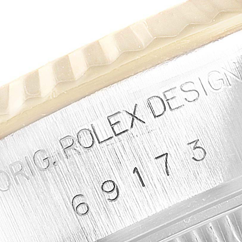 This image shows a close-up of the engraved side of the bezel and case of a Rolex Datejust 69173 Women
s Steel and Gold (two tone) Silver Dial 69173 Women
s Steel and Gold (two tone) Silver Dial watch.