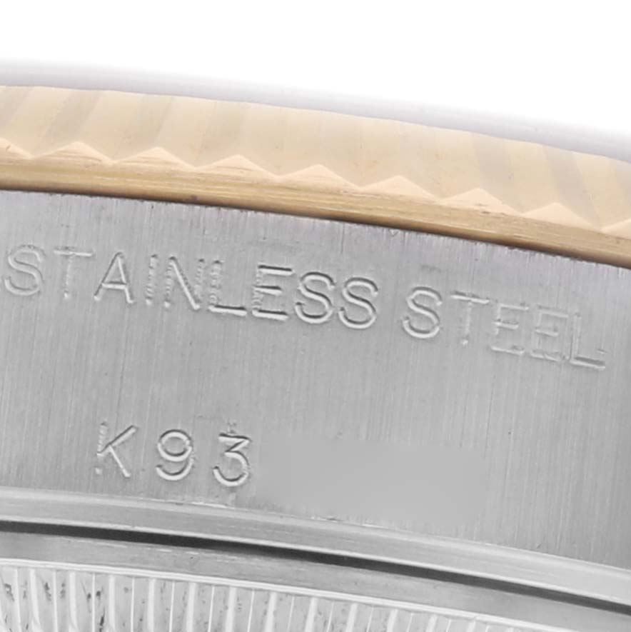 This close-up image shows part of the Rolex Datejust 79173 Women's Steel and Gold (two tone) Silver Dial 79173 Women's Steel and Gold (two tone) Silver Dial watch case with "STAINLESS STEEL" engraving.
