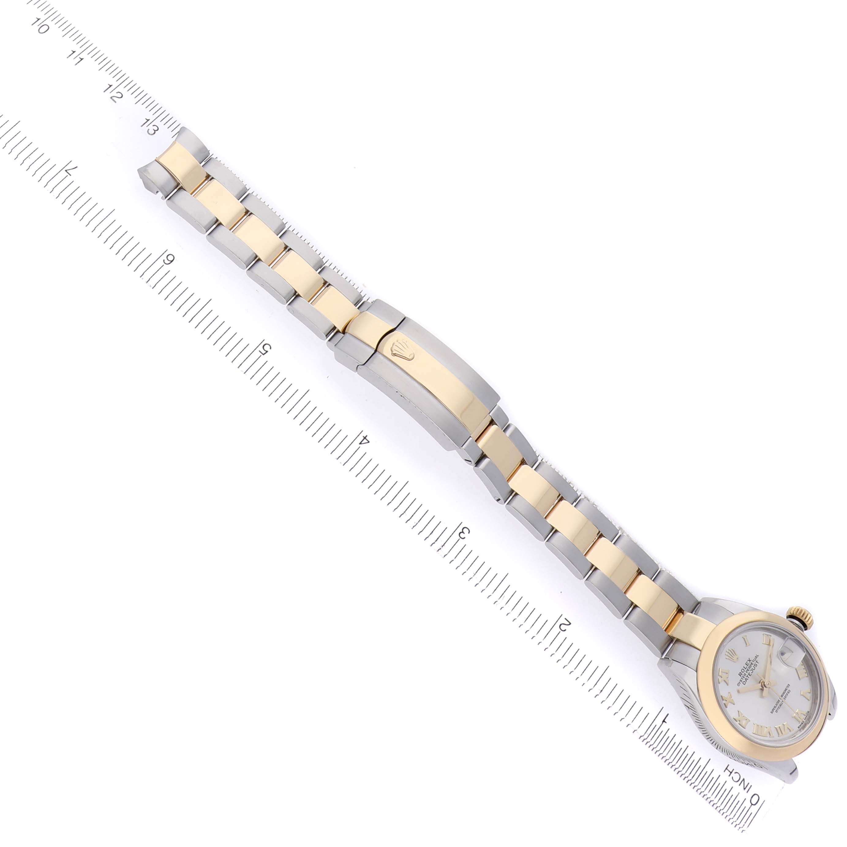 The Rolex Datejust 279163 Women's Steel and Gold (two tone) Silver Dial 279163 Women's Steel and Gold (two tone) Silver Dial watch is shown from a top-down angle, highlighting the bracelet and clasp alongside a measuring ruler.