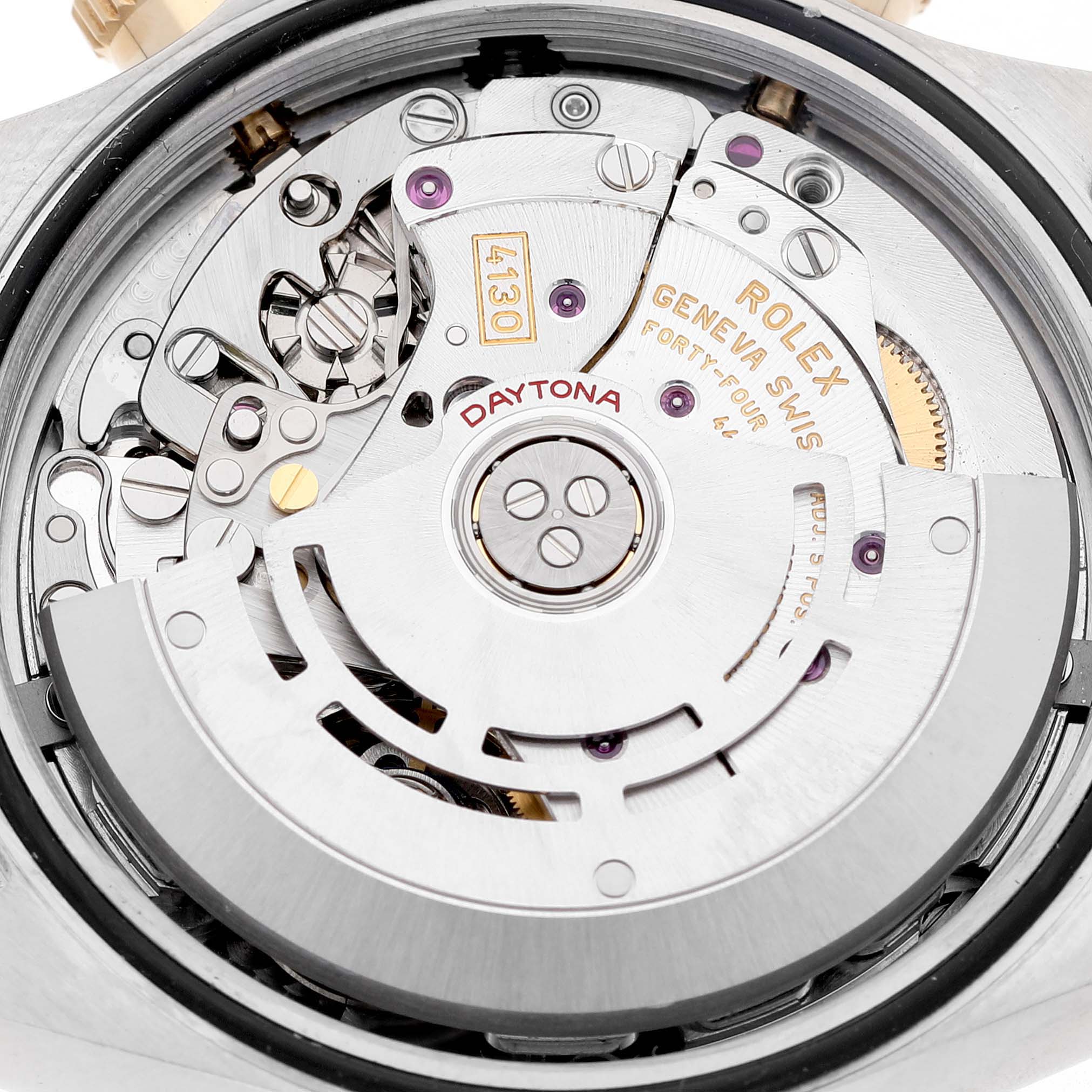 The image shows the movement of a Rolex Daytona 116523 Men's Steel and Gold (two tone) Silver Dial watch from a top-down angle, highlighting gears and the rotor.
