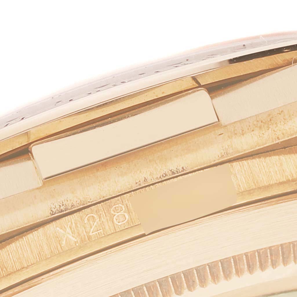 This close-up image shows the side and edge of the bezel of a Rolex Daytona 16518 Men's Yellow Gold White Dial 16518 Men's Yellow Gold White Dial watch.