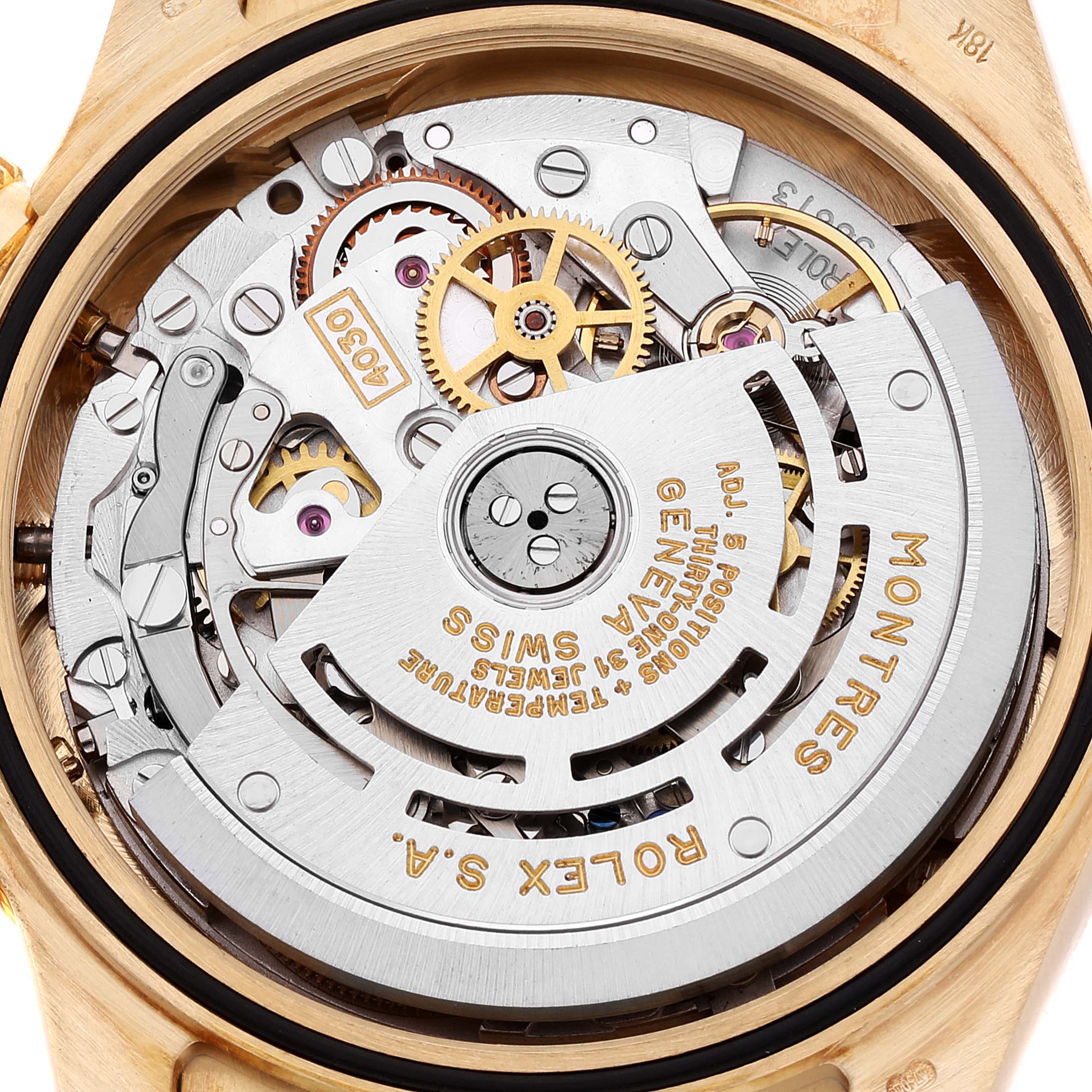 This image shows the back angle of the Rolex Daytona 16518 Men's Yellow Gold White Dial 16518 Men's Yellow Gold White Dial watch, displaying its intricate movement and inner mechanical parts.