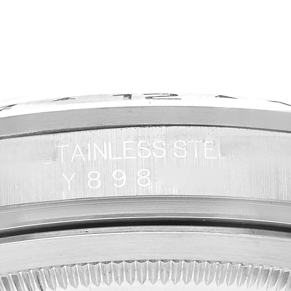 This close-up photo shows the side of the case of a Rolex Explorer 16570 Men
s Stainless Steel Black Dial 16570 Men
s Stainless Steel Black Dial watch, highlighting the stainless steel material and part of its serial number.