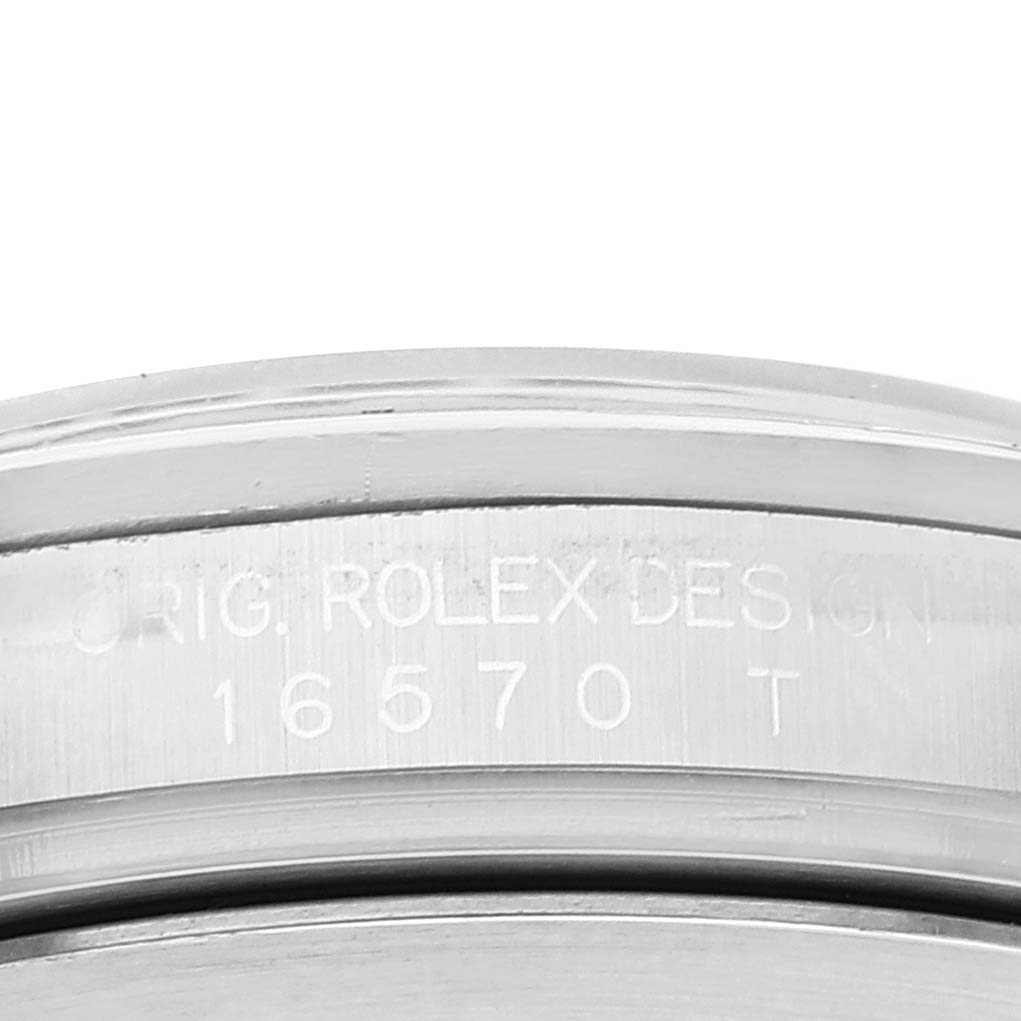 The image shows a close-up of the engraved case back of a Rolex Explorer 16570 Men
s Stainless Steel Black Dial 16570 Men
s Stainless Steel Black Dial watch, highlighting the model number "16570."