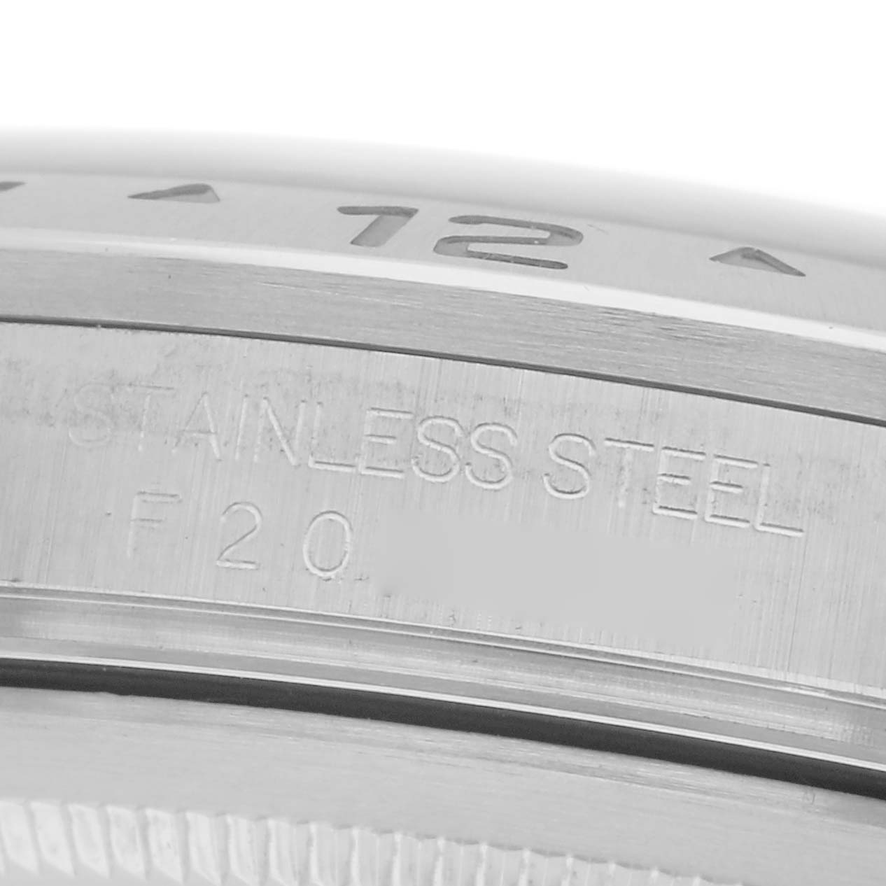 The image shows a close-up of the stainless steel bezel and engraving on a Rolex Explorer 16570 Men
s Stainless Steel Black Dial 16570 Men
s Stainless Steel Black Dial watch.