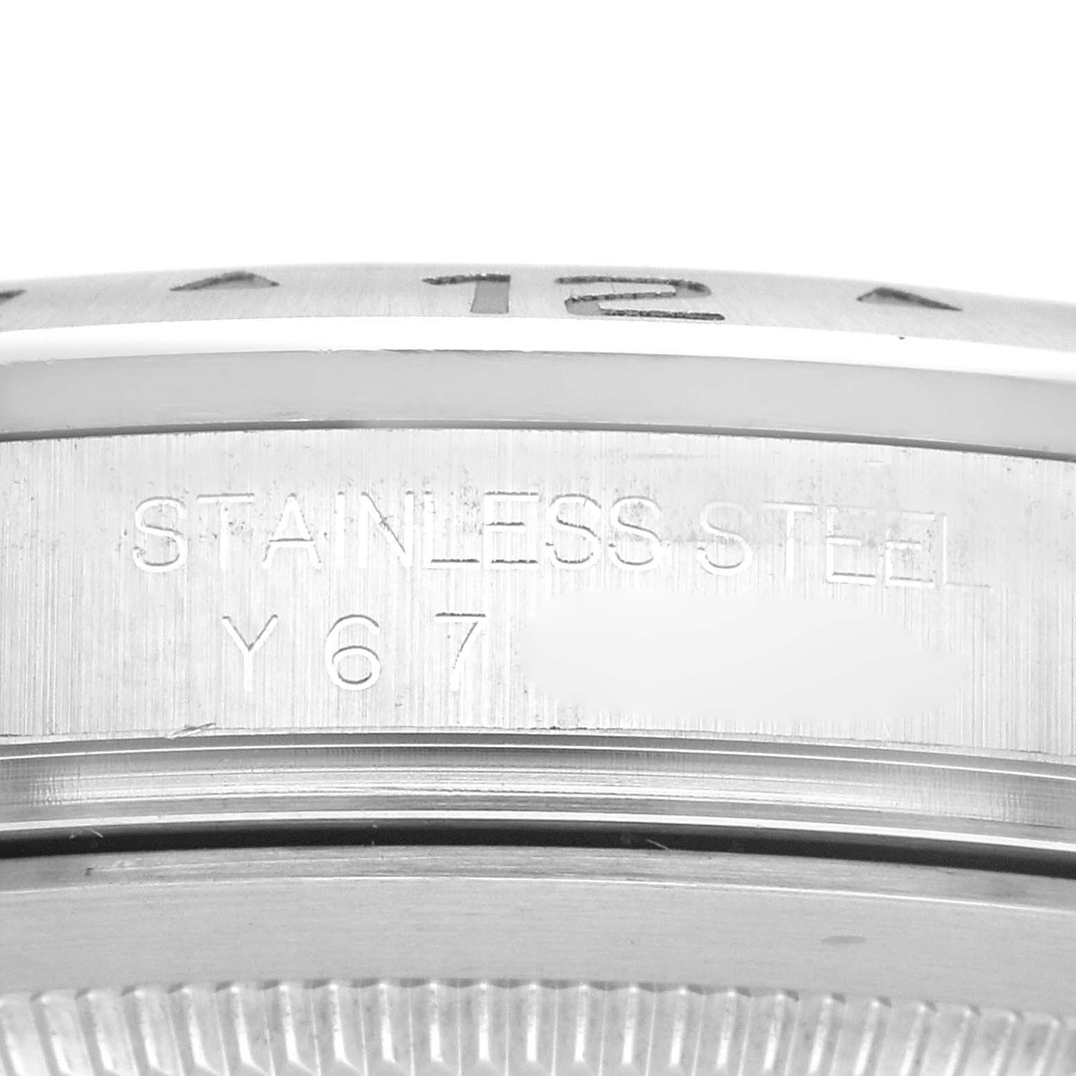 The image shows a close-up of the side of a Rolex Explorer 16570 Men's Stainless Steel White Dial 16570 Men's Stainless Steel White Dial watch case, highlighting the "STAINLESS STEEL" engraving.