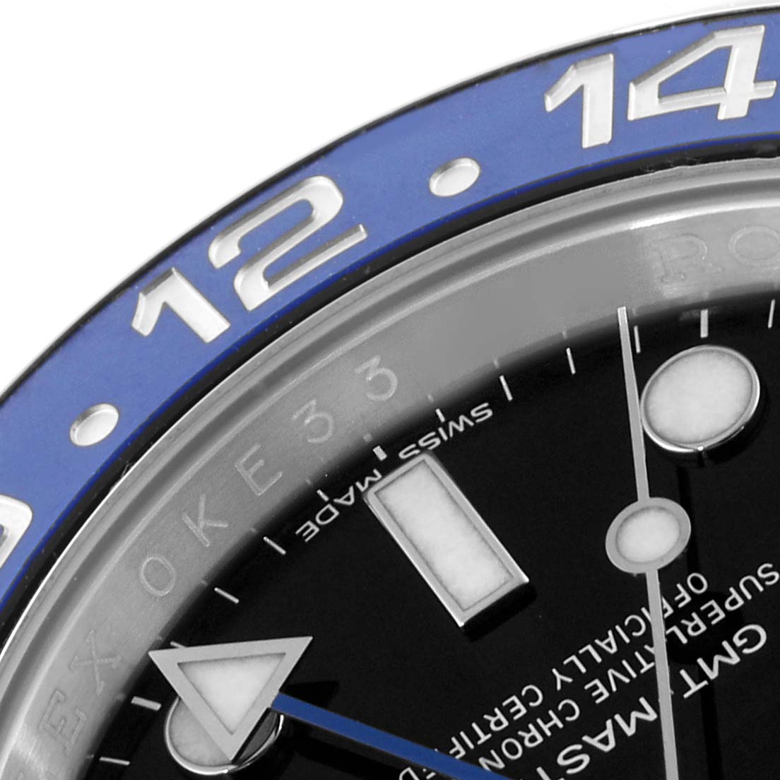 The image shows a close-up of a Rolex GMT-Master 116710BLNR Men's Stainless Steel Black Dial 116710BLNR Men's Stainless Steel Black Dial watch dial and part of its bezel, focusing on the 12 and 14-hour marks.