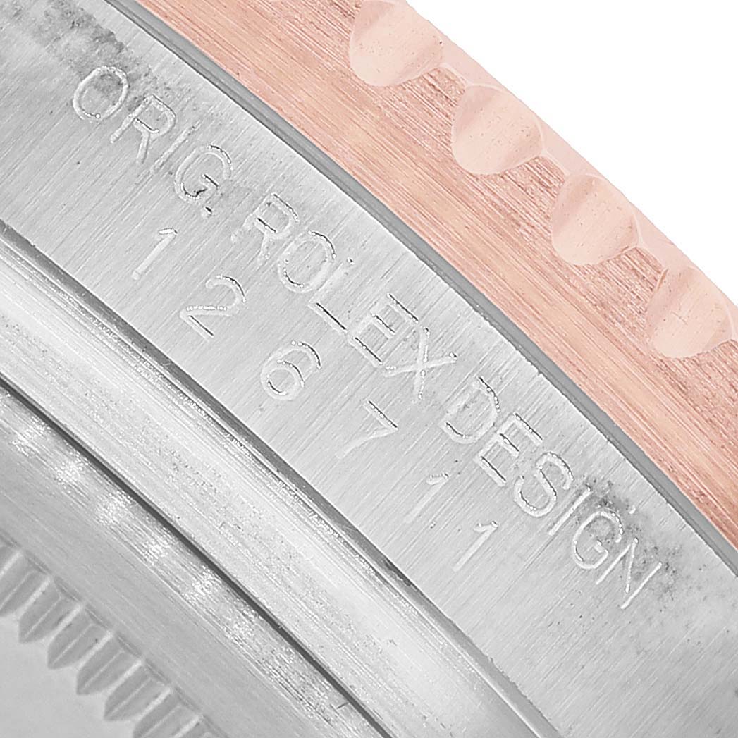 The image shows a close-up of the side of a Rolex GMT-Master 126711CHNR Men's Steel and Gold (two tone) Black Dial watch, highlighting the engraved model number and part of the bezel.