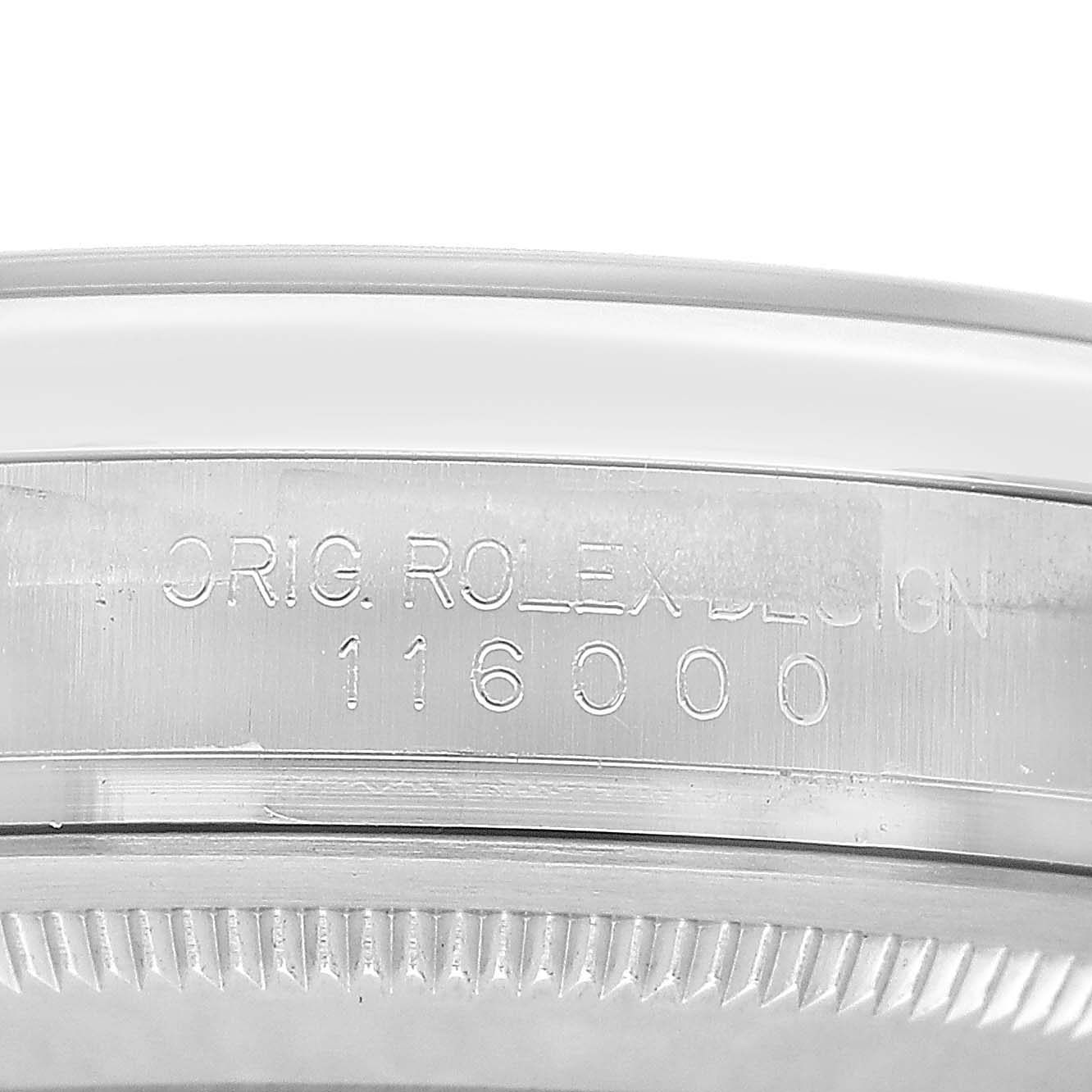 The image shows a close-up of the side engraving on a Rolex Oyster Perpetual 116000 Men's Stainless Steel Silver Dial watch case, displaying "ORIG. ROLEX DESIGN 116000."