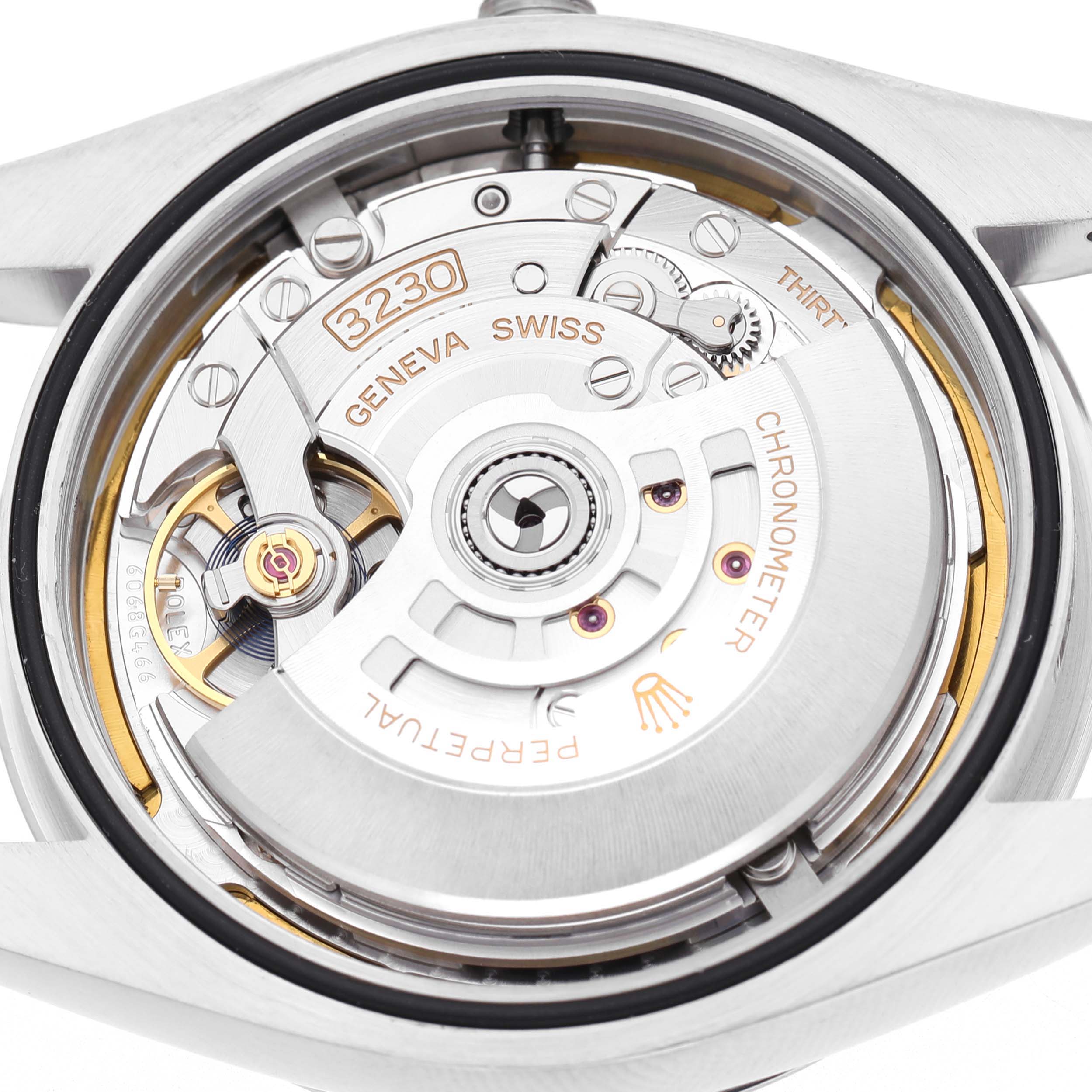 The image shows the movement of a Rolex Oyster Perpetual M124300-0005 Men's Stainless Steel Green Dial watch, highlighting the intricate mechanisms from a rear angle.