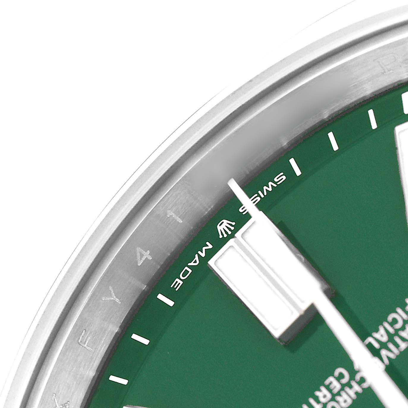The image shows a close-up of the Oyster Perpetual watch by Rolex, focusing on part of the green dial and hands.