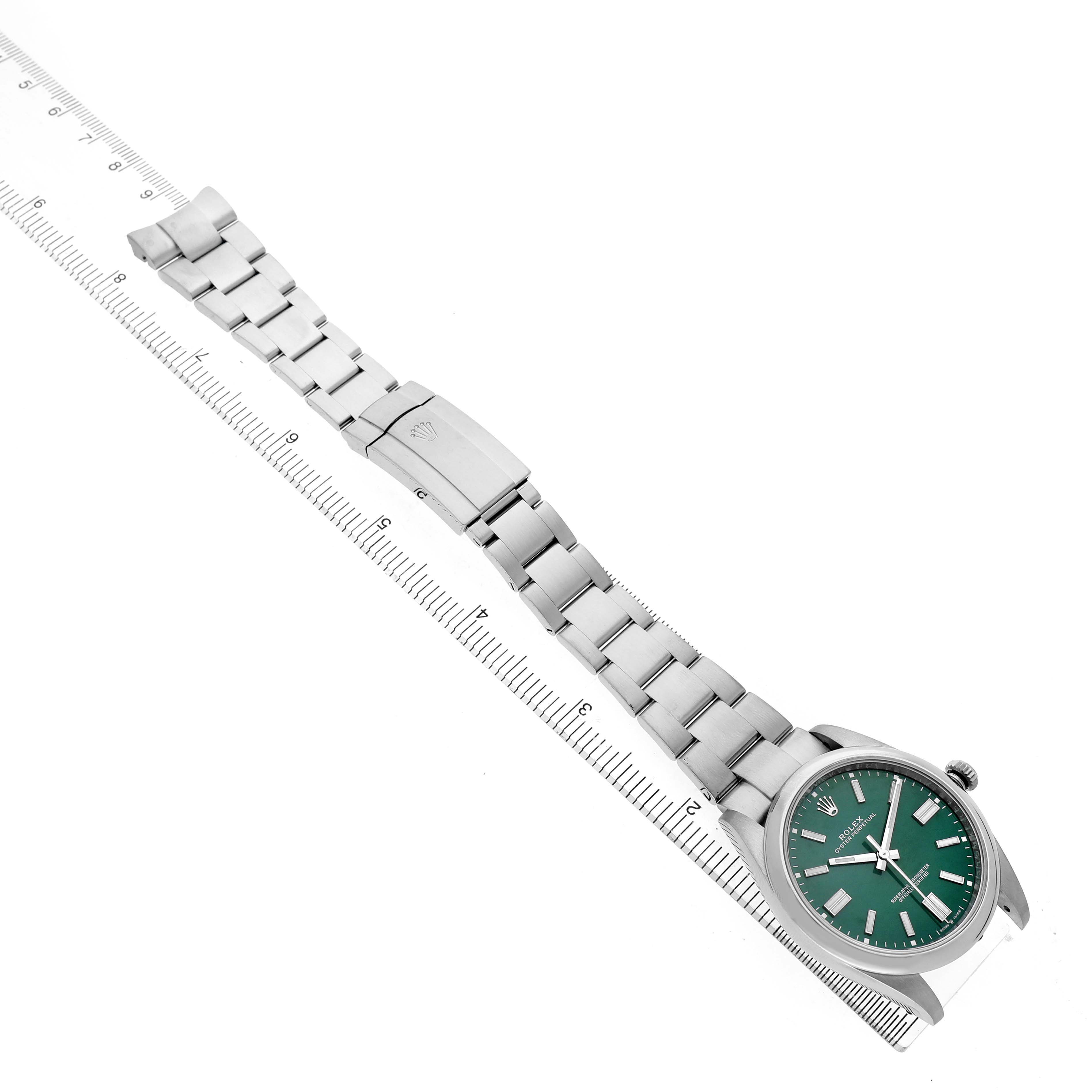 The Rolex Oyster Perpetual M124300-0005 Men's Stainless Steel Green Dial watch is shown at an angled top view, highlighting the bracelet, clasp, and green dial face.