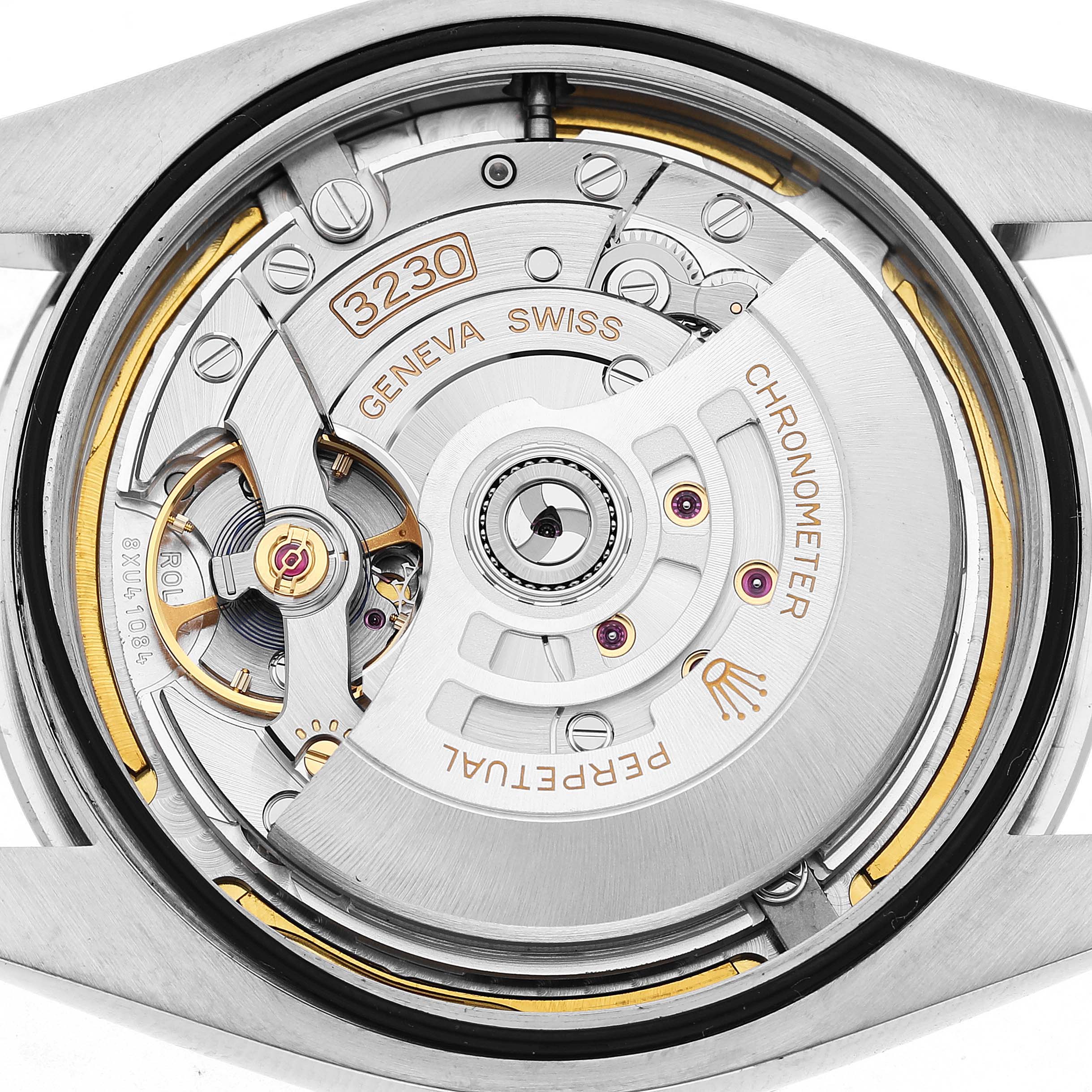The image shows the movement and internal mechanics of a Rolex Oyster Perpetual M124300-0005 Men's Stainless Steel Green Dial watch, viewed from the back.