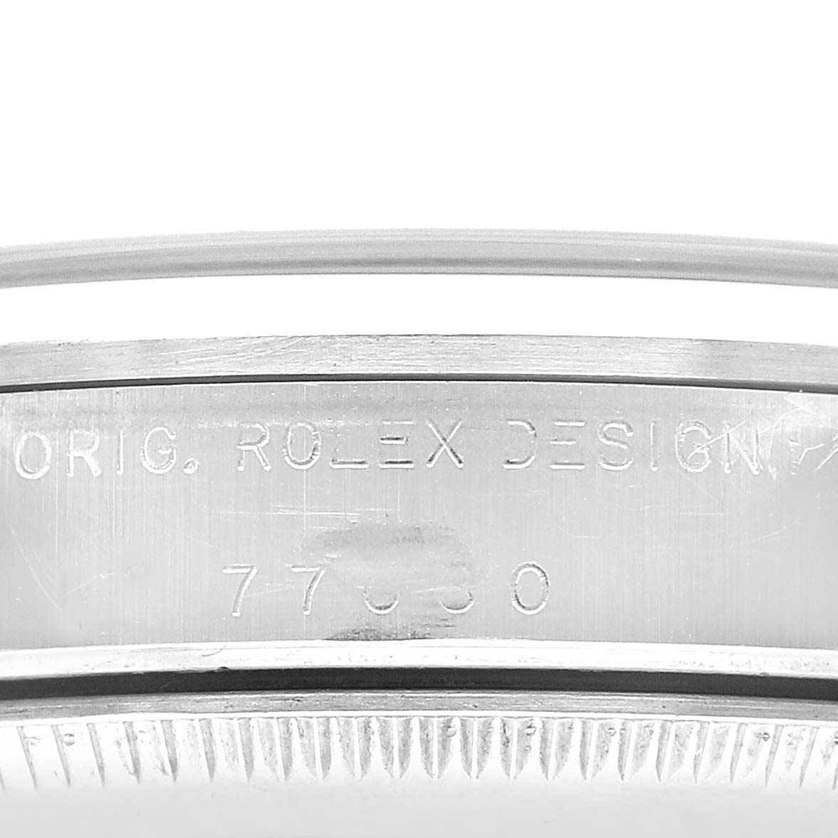 The image shows the side engraving on the case of a Rolex Oyster Perpetual 77080 Women's Stainless Steel Black Dial, highlighting the brand and model details.