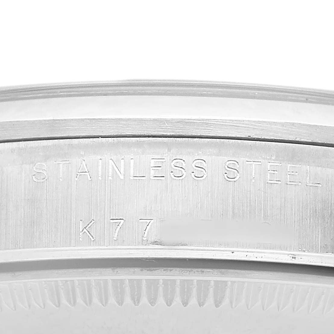 The image shows the side view of the stainless steel case back of a Rolex Oyster Perpetual 77080 Women's Stainless Steel Black Dial watch.