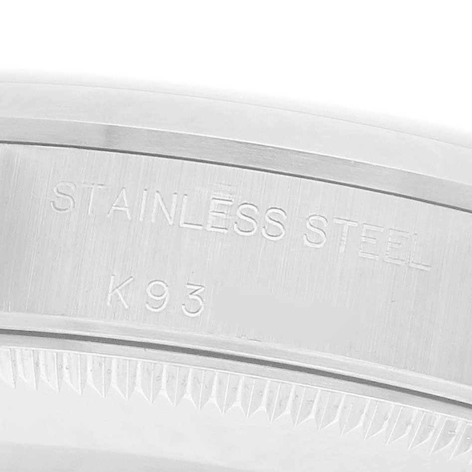 The image shows a close-up of the side engraving on a Rolex Oyster Perpetual 72105 Women's Stainless Steel Pink Dial 72105 Women's Stainless Steel Pink Dial, highlighting "STAINLESS STEEL" and "K93".