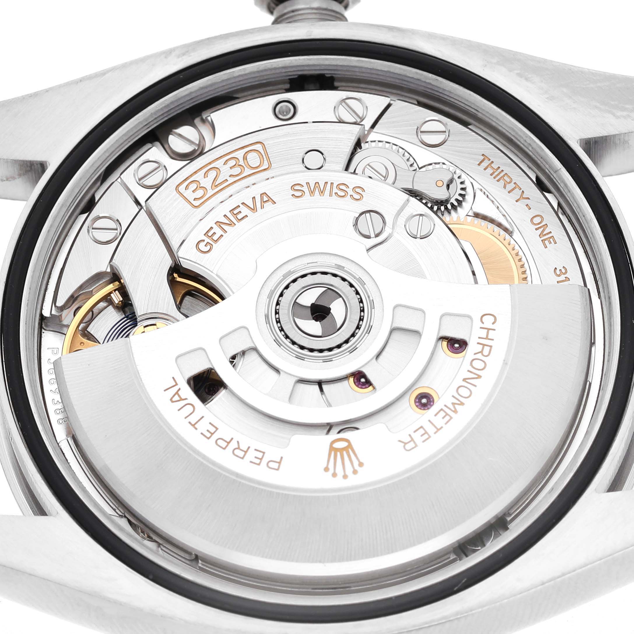The image shows the movement of a Rolex Oyster Perpetual 126000 Men's Stainless Steel Black Dial, highlighting the rotor and internal mechanics.