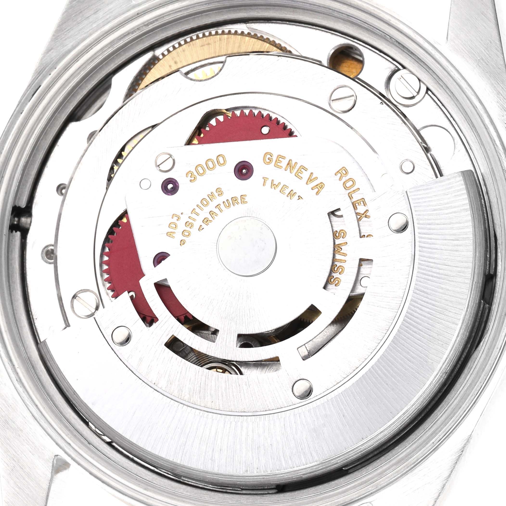 The image shows the movement of a Rolex Oyster Perpetual 14203 Men
s Steel and Gold (two tone) Champagne Dial 14203 Men
s Steel and Gold (two tone) Champagne Dial, viewed from the back, highlighting its intricate gears and inscriptions.
