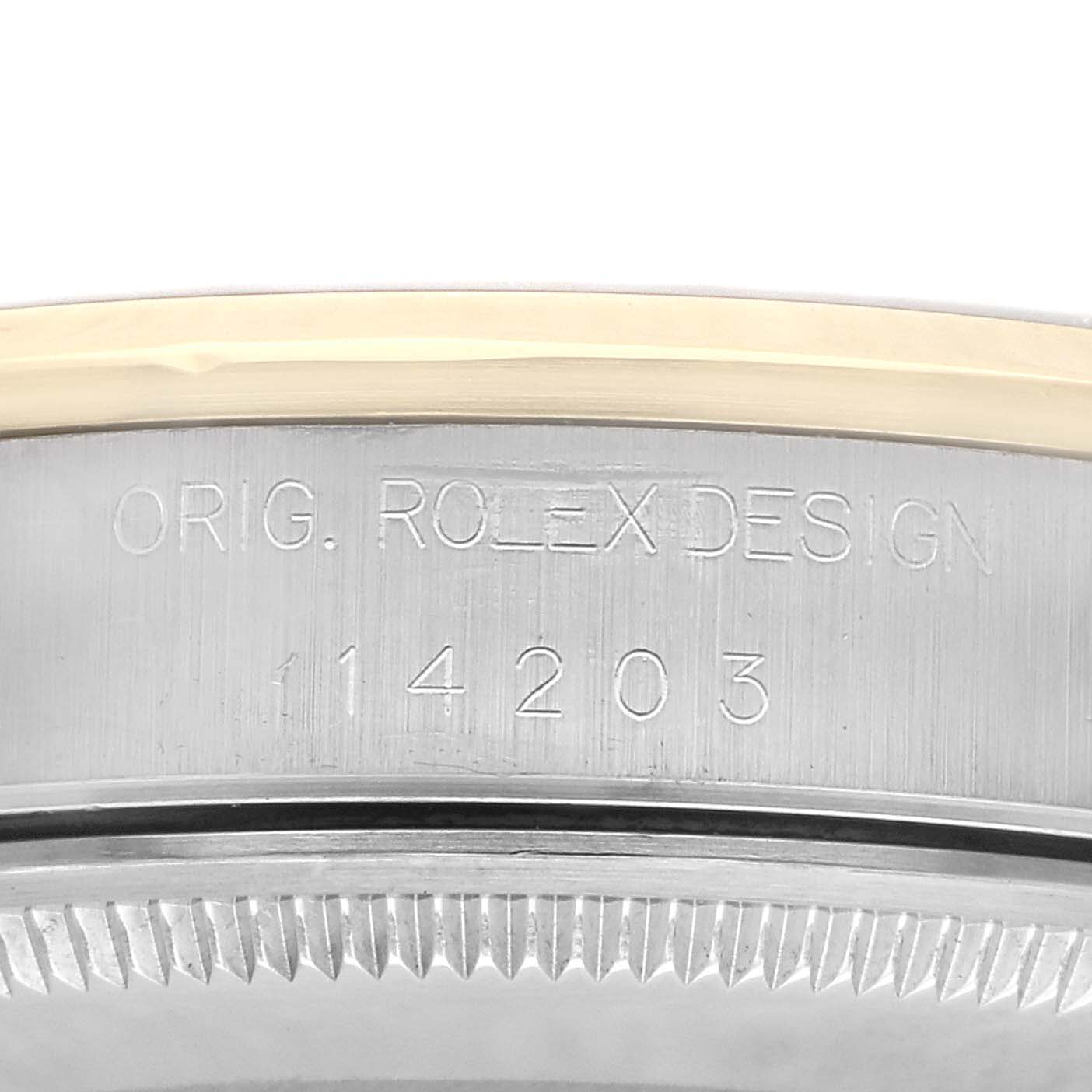The image shows a close-up of the side of a Rolex Oyster Perpetual 14203 Men
s Steel and Gold (two tone) Champagne Dial 14203 Men
s Steel and Gold (two tone) Champagne Dial watch, highlighting the “Orig. Rolex Design” engraving and model number.