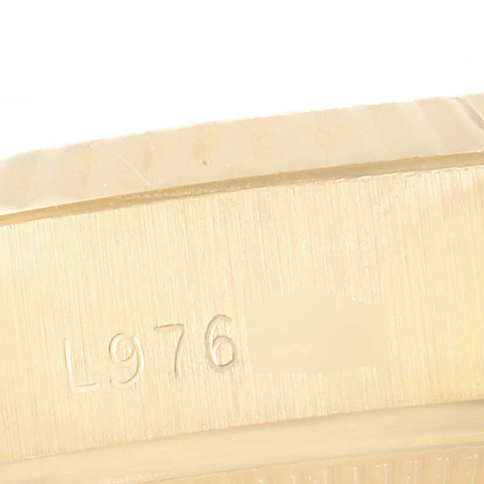 This image shows a close-up of the engraved serial number on the case of a Rolex President 69178 Women's Yellow Gold Silver Dial 69178 Women's Yellow Gold Silver Dial model watch.