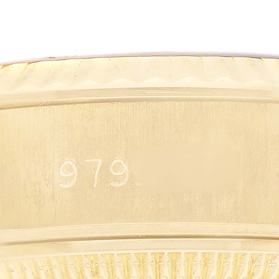 The image shows a close-up view of the Rolex President 69178 Women's Yellow Gold Champagne Dial model's side, highlighting the case's engravings and edge details.