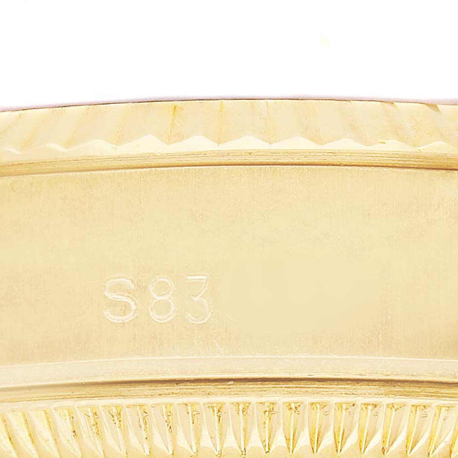 The image shows a close-up of the side of a Rolex President 69178 Men's Yellow Gold Champagne Dial watch, highlighting the edge and textured bezel.