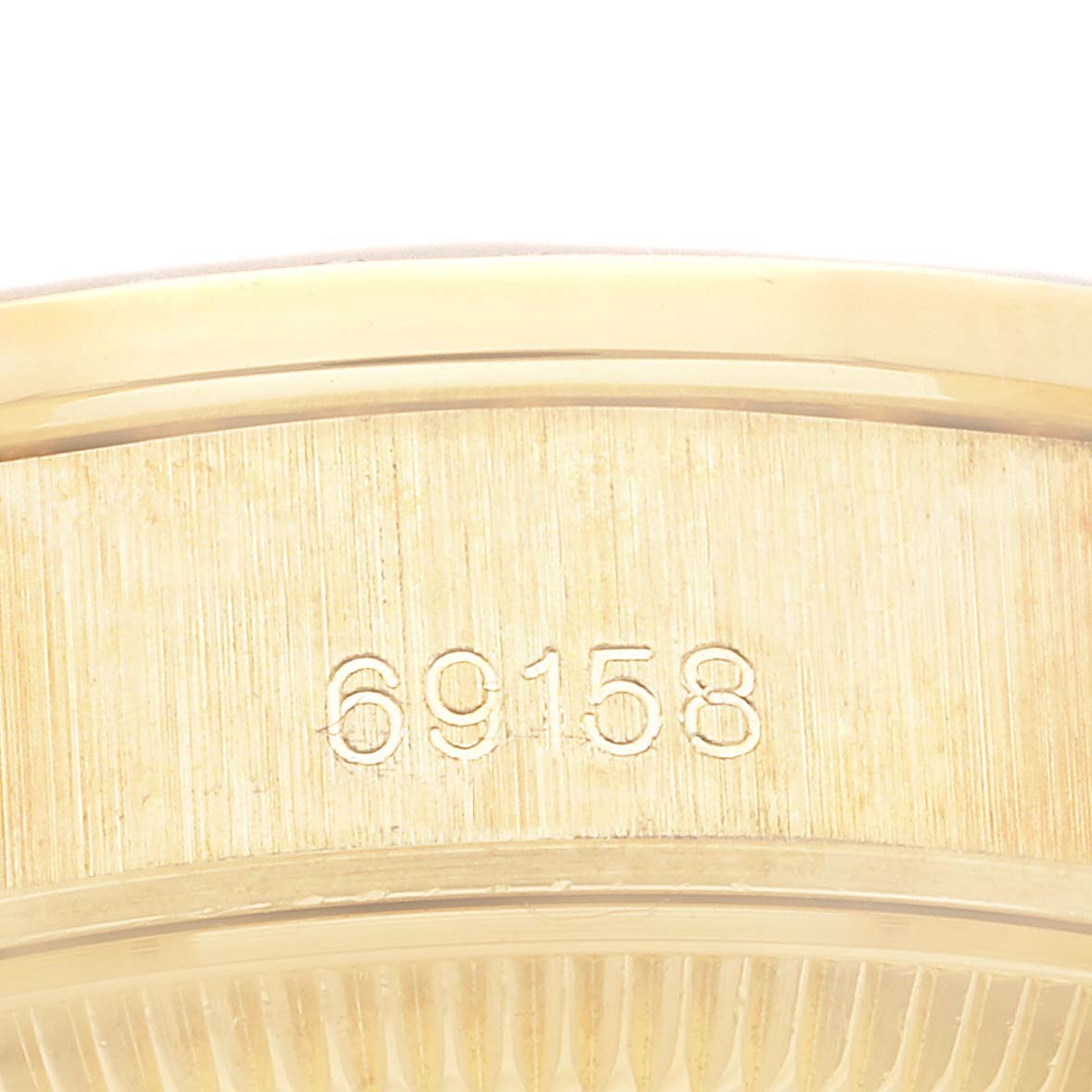 The image shows a close-up of the case back for the Rolex President 69158 Women's Yellow Gold White Dial 69158 Women's Yellow Gold White Dial model 69158, highlighting the model number engraving.