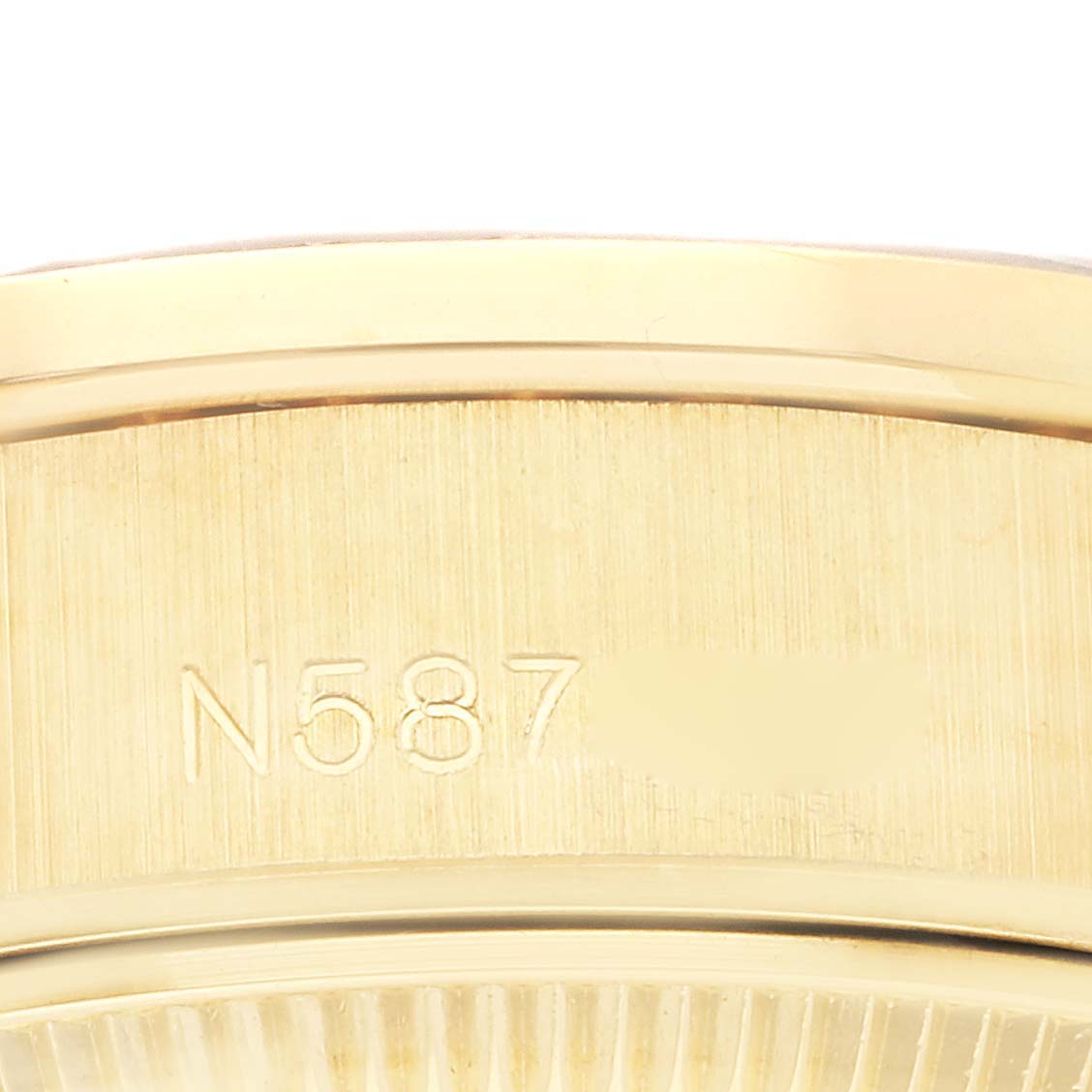 This image shows a close-up of the serial number engraving on a Rolex President 69158 Women's Yellow Gold White Dial 69158 Women's Yellow Gold White Dial model watch.