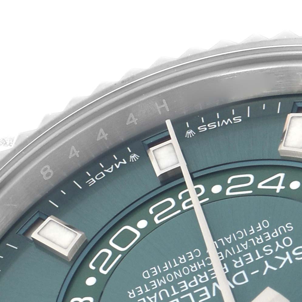 The image shows a close-up of the Rolex Sky-Dweller 336934 Men
s Stainless Steel Green Dial 336934 Men
s Stainless Steel Green Dial
s dial, focusing on the hour markers, 24-hour display, and part of the bezel.