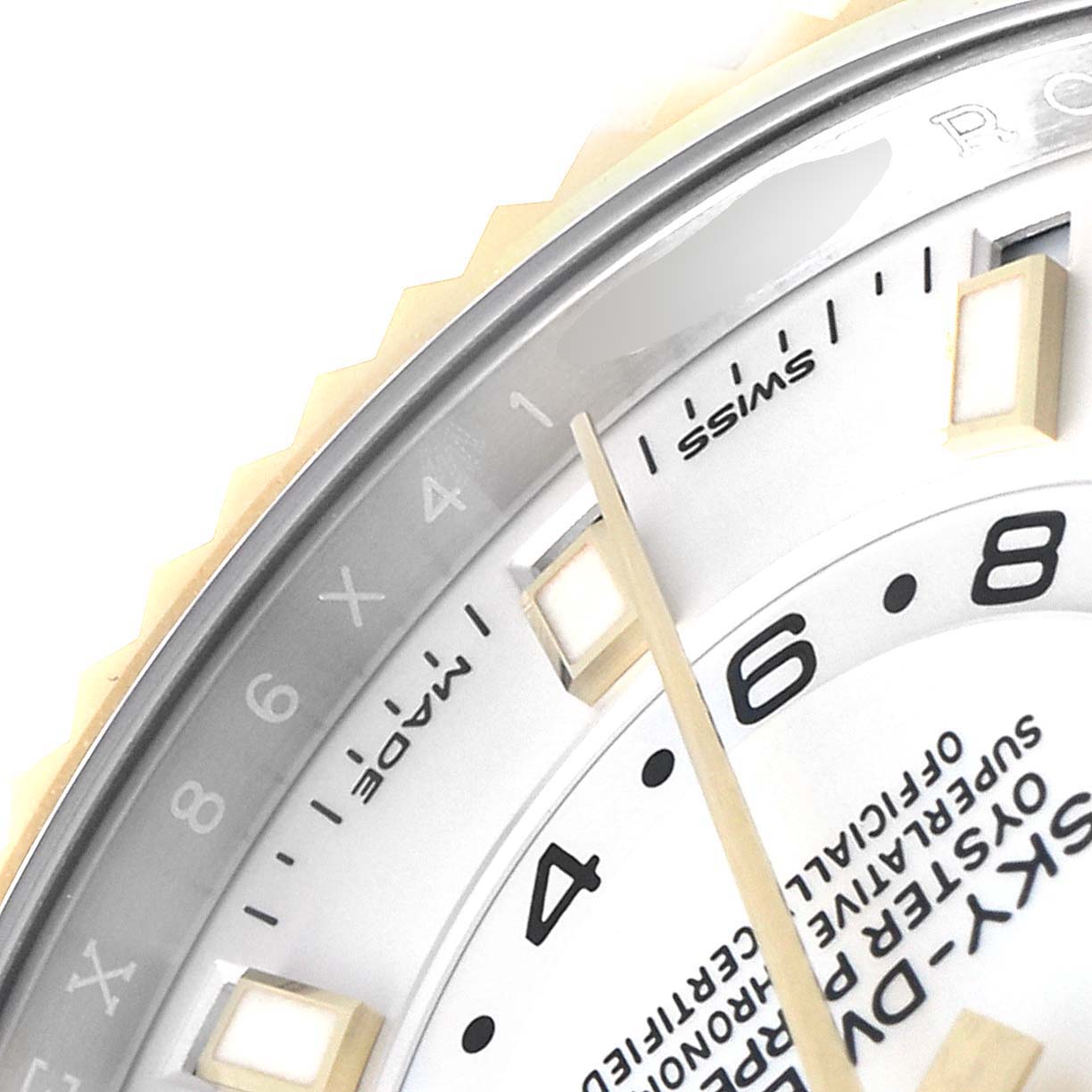 This close-up shows the dial, bezel, and part of the hand of a Rolex Sky-Dweller 326933 Men's Steel and Gold (two tone) White Dial 326933 Men's Steel and Gold (two tone) White Dial watch, highlighting the numeral markers and text.