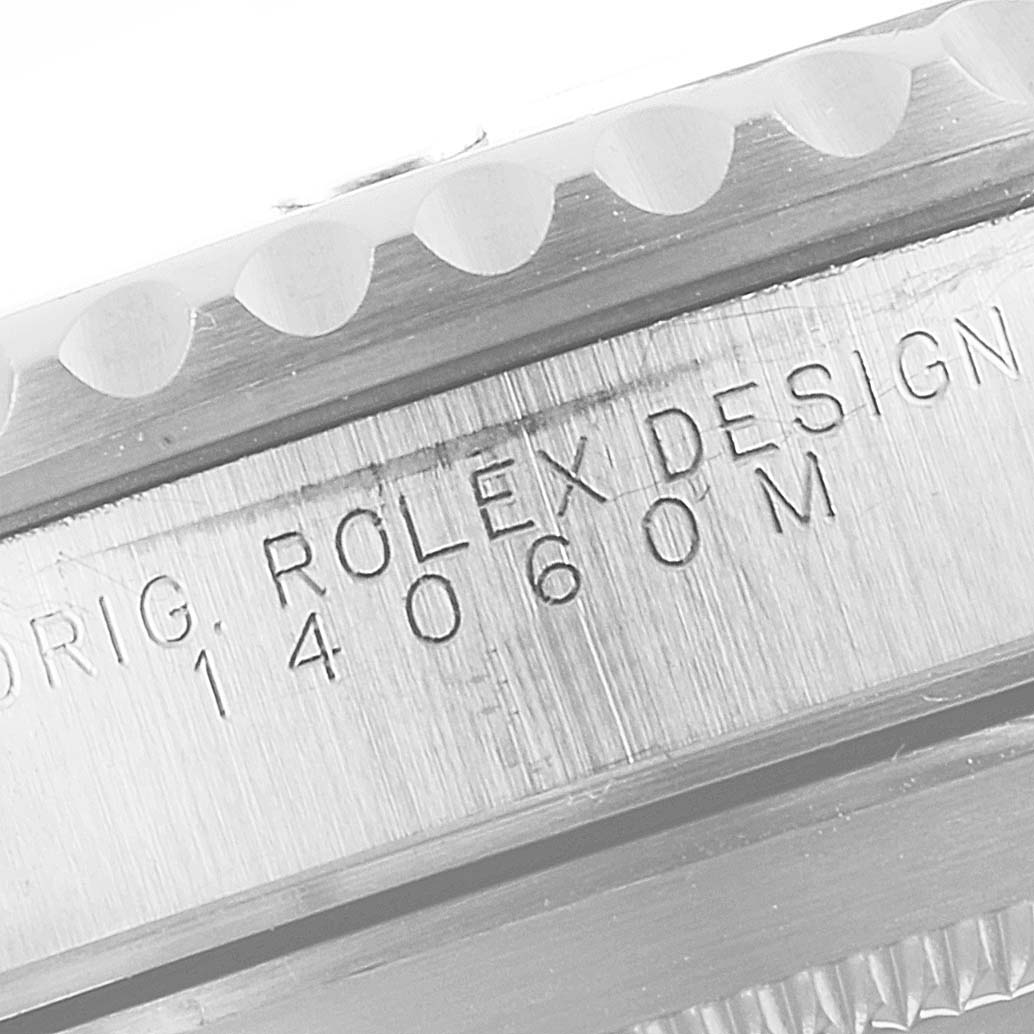 This close-up image shows the engraved serial number and "ROLEX DESIGN" on the side of the case of a Rolex Submariner 14060 Men
s Stainless Steel Black Dial 14060 Men
s Stainless Steel Black Dial watch.